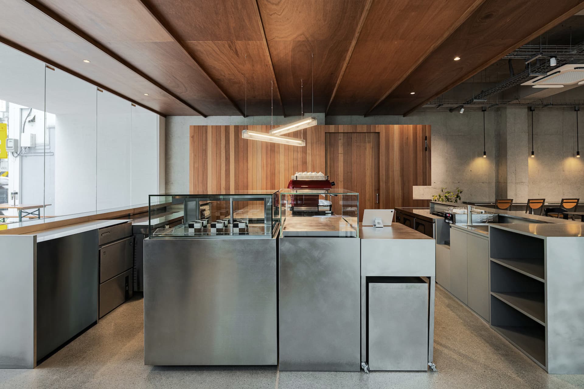 Industrial-style restaurant interior featuring an acrylic counter and modern lighting.