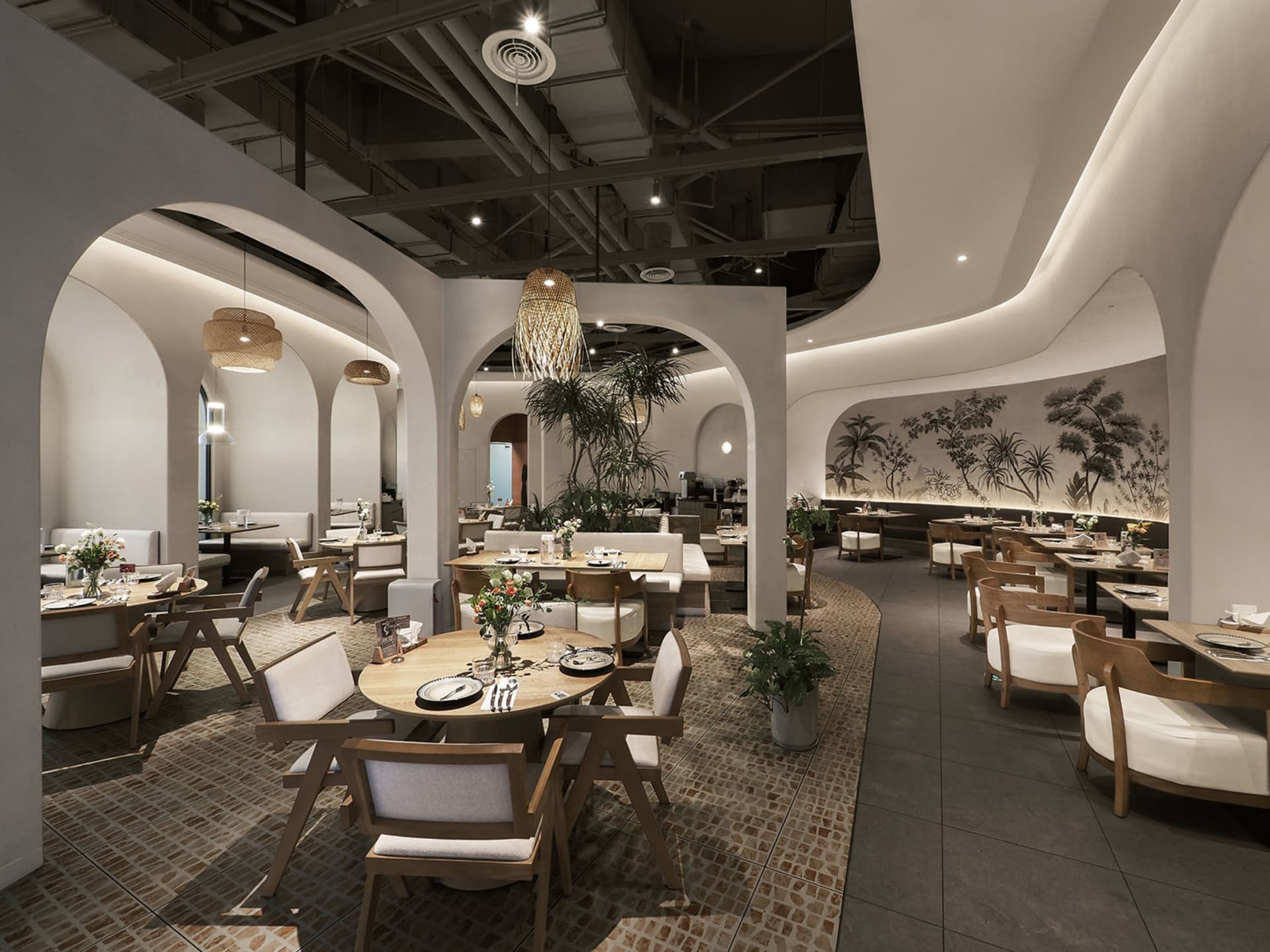 A modern restaurant interior featuring white walls, wood furniture, and ceramic tiles.