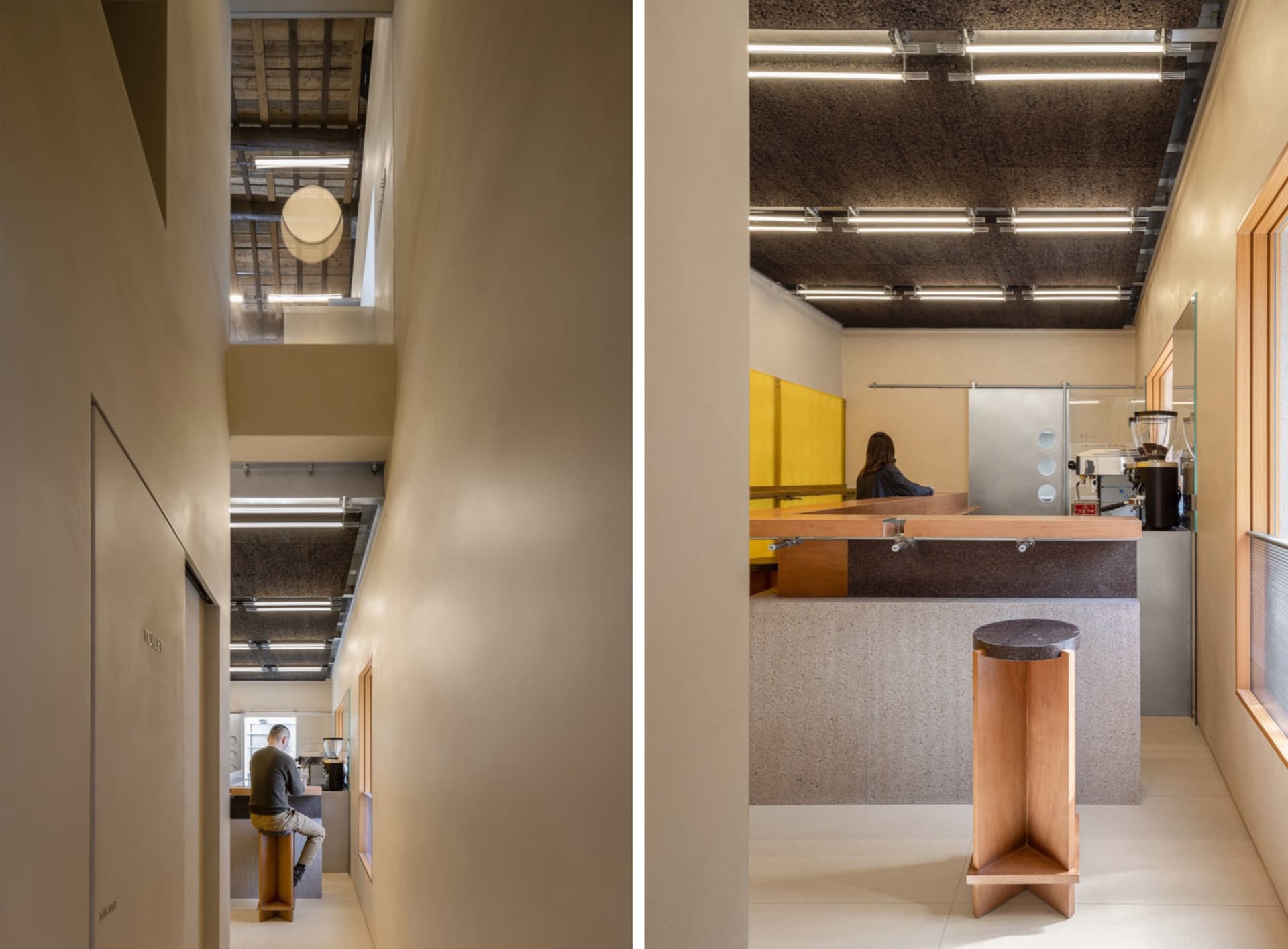 A modern coffee shop interior featuring a concrete and wooden counter.