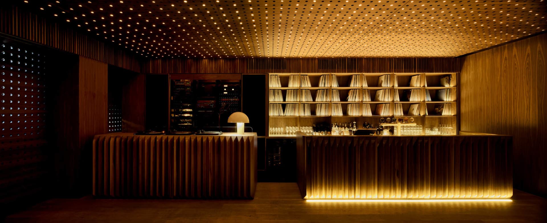 Industrial style restaurant bar with wooden counter and lighting