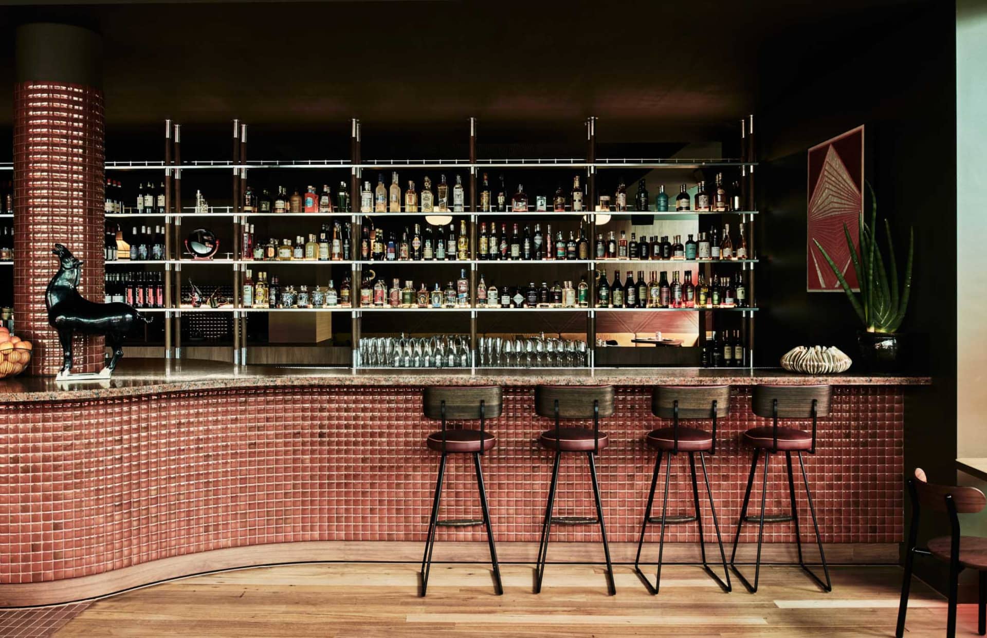 Industrial-themed bar interior with tile and concrete finishes