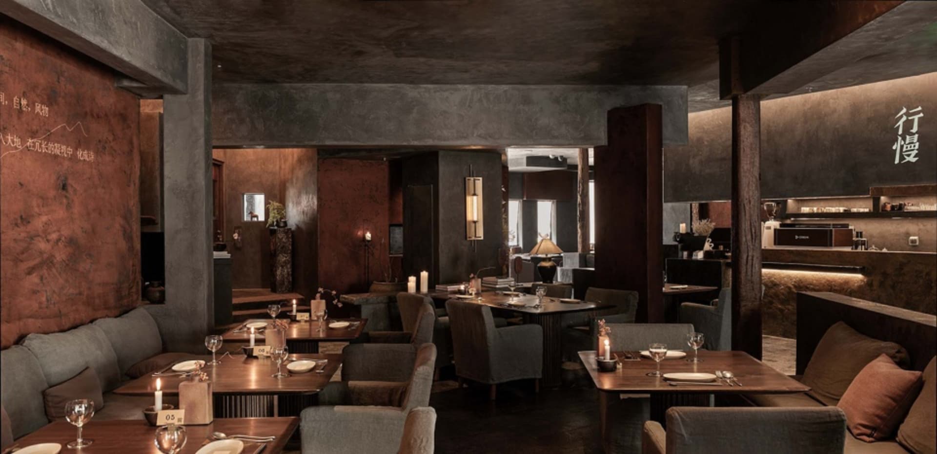 An industrial-themed restaurant with metallic walls, concrete floors, and loft-style design.
