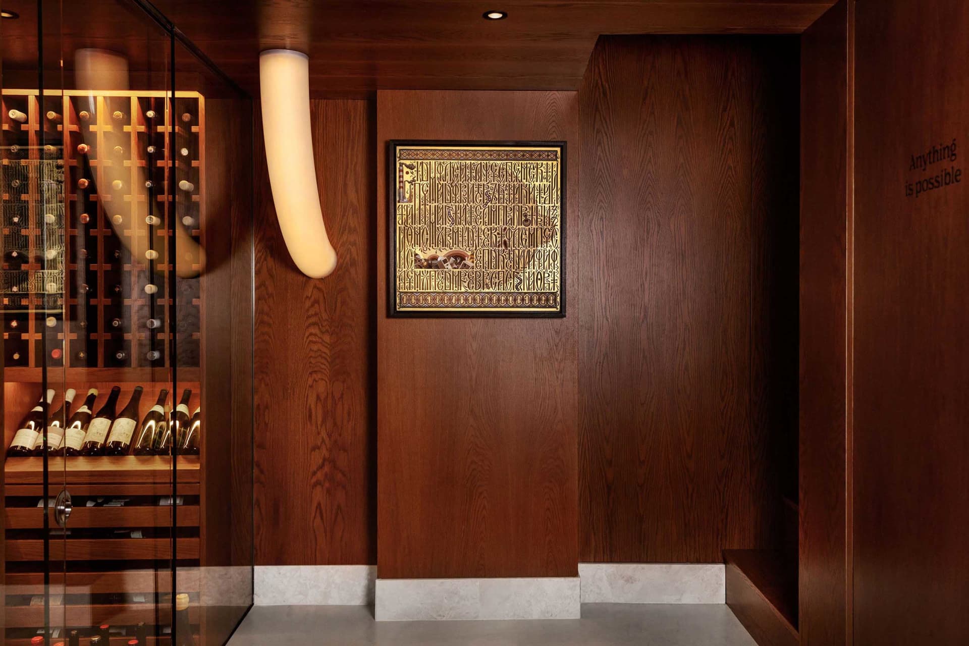 Modern interior design featuring a sleek, contemporary wine cellar with dark wooden panels, glass shelves, and a minimalist s