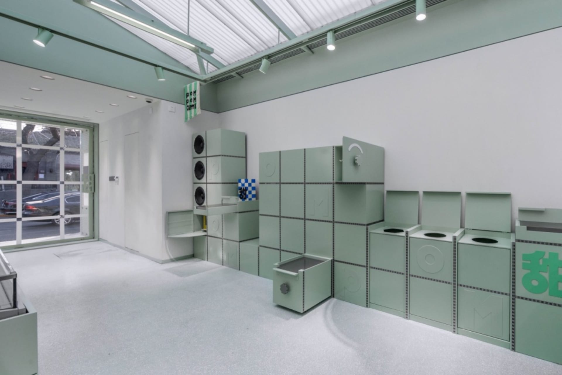 A minimalist storefront featuring green paneling.