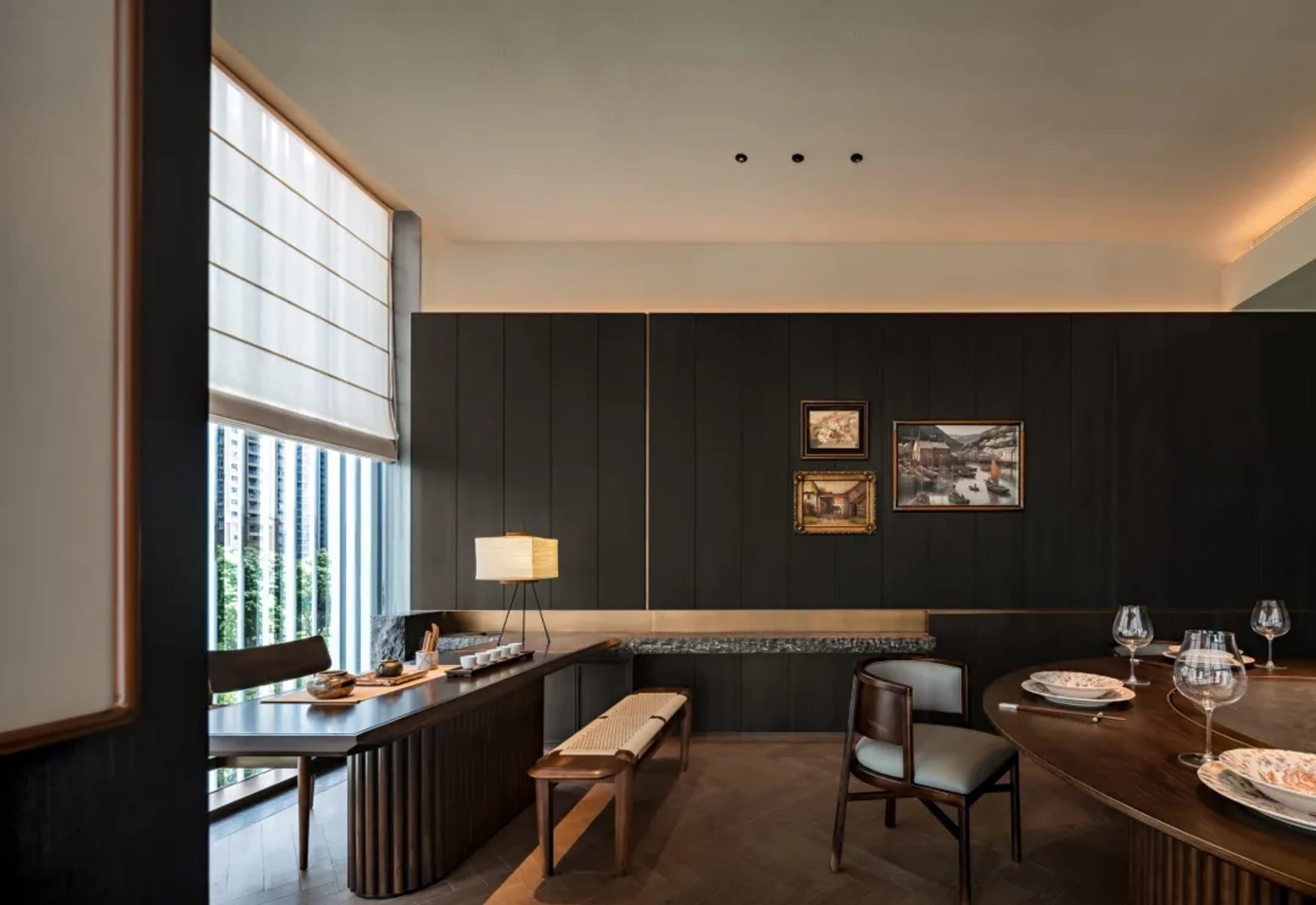 A modern dining room with wooden furniture and a large window.