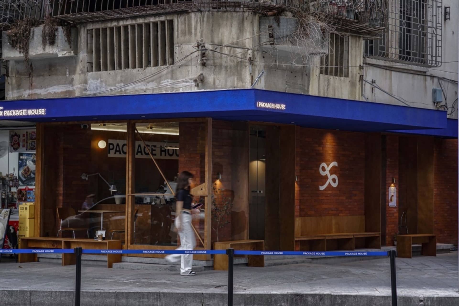 A modern retail storefront with industrial design elements and brick exterior.