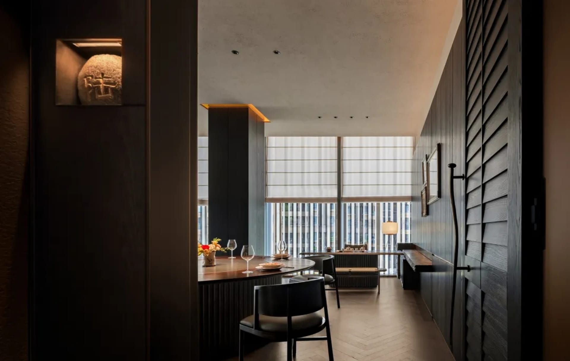 A minimalist restaurant interior featuring wooden tables, glass windows, and metallic accents.