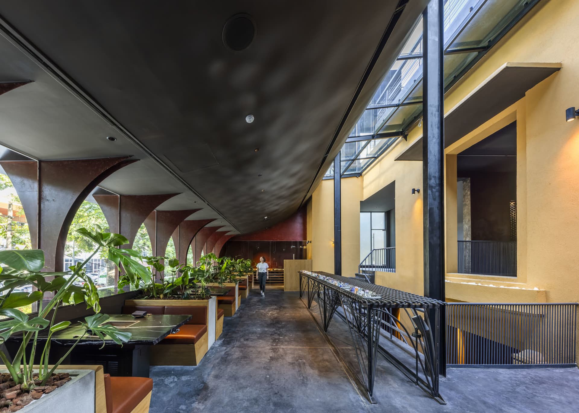 Modern industrial restaurant interior with concrete and glass elements