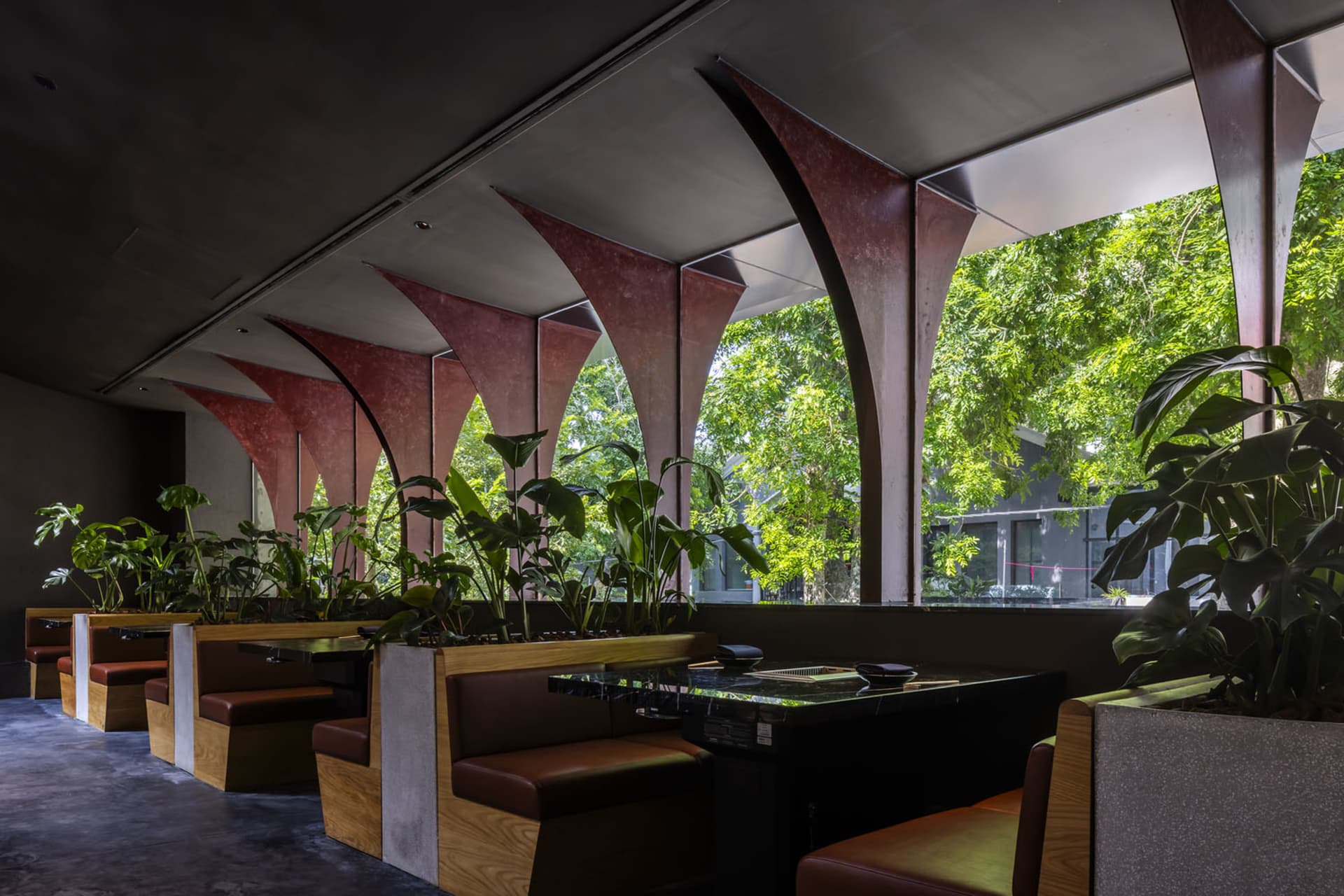 Industrial-style restaurant interior with wooden seating and ceiling