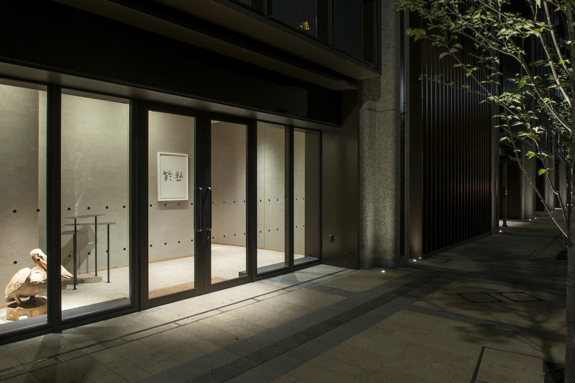 Modern retail storefront with glass doors and interior lighting.