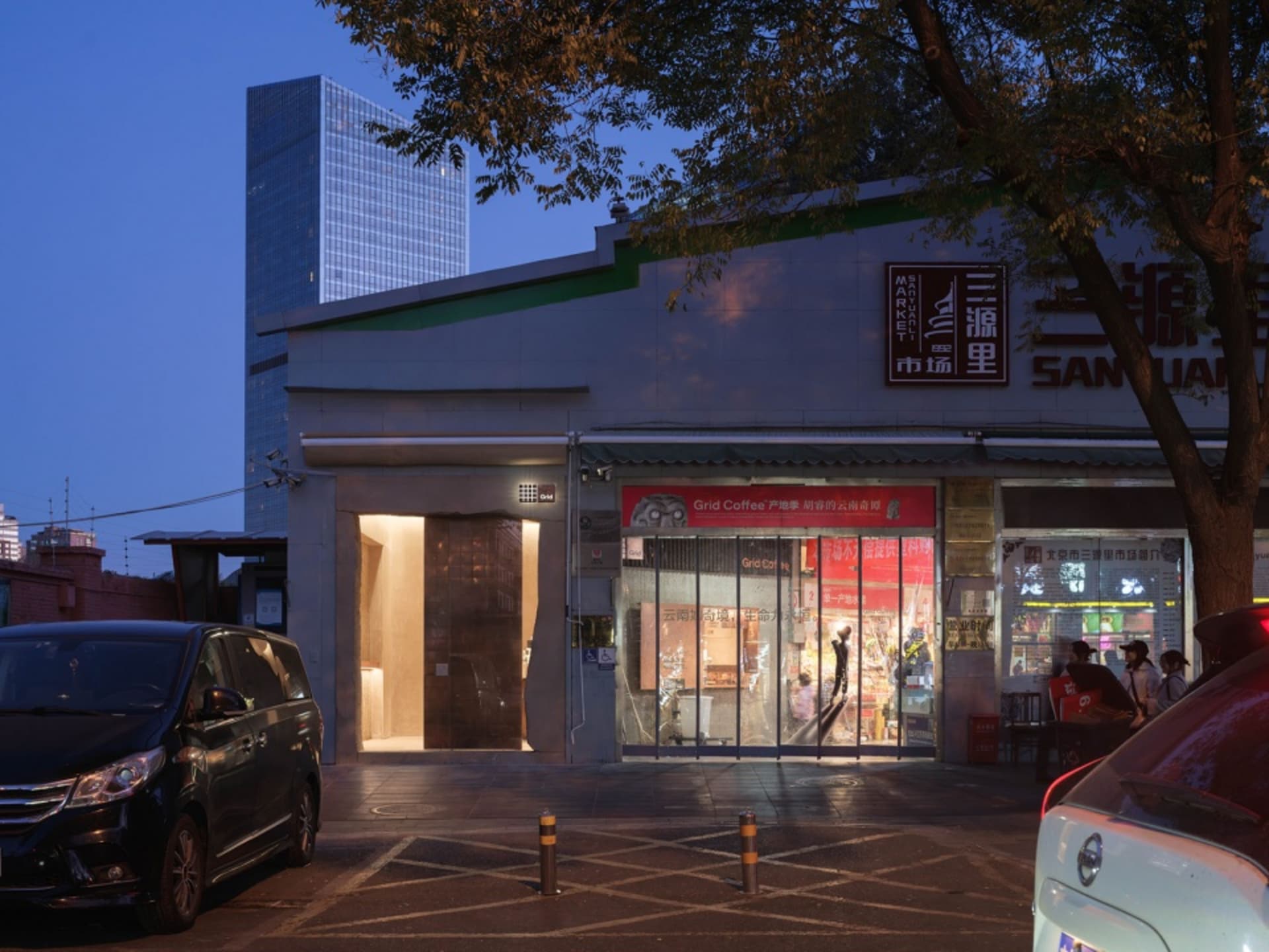 Modern storefront featuring a glass facade, concrete pillars, and metal elements.