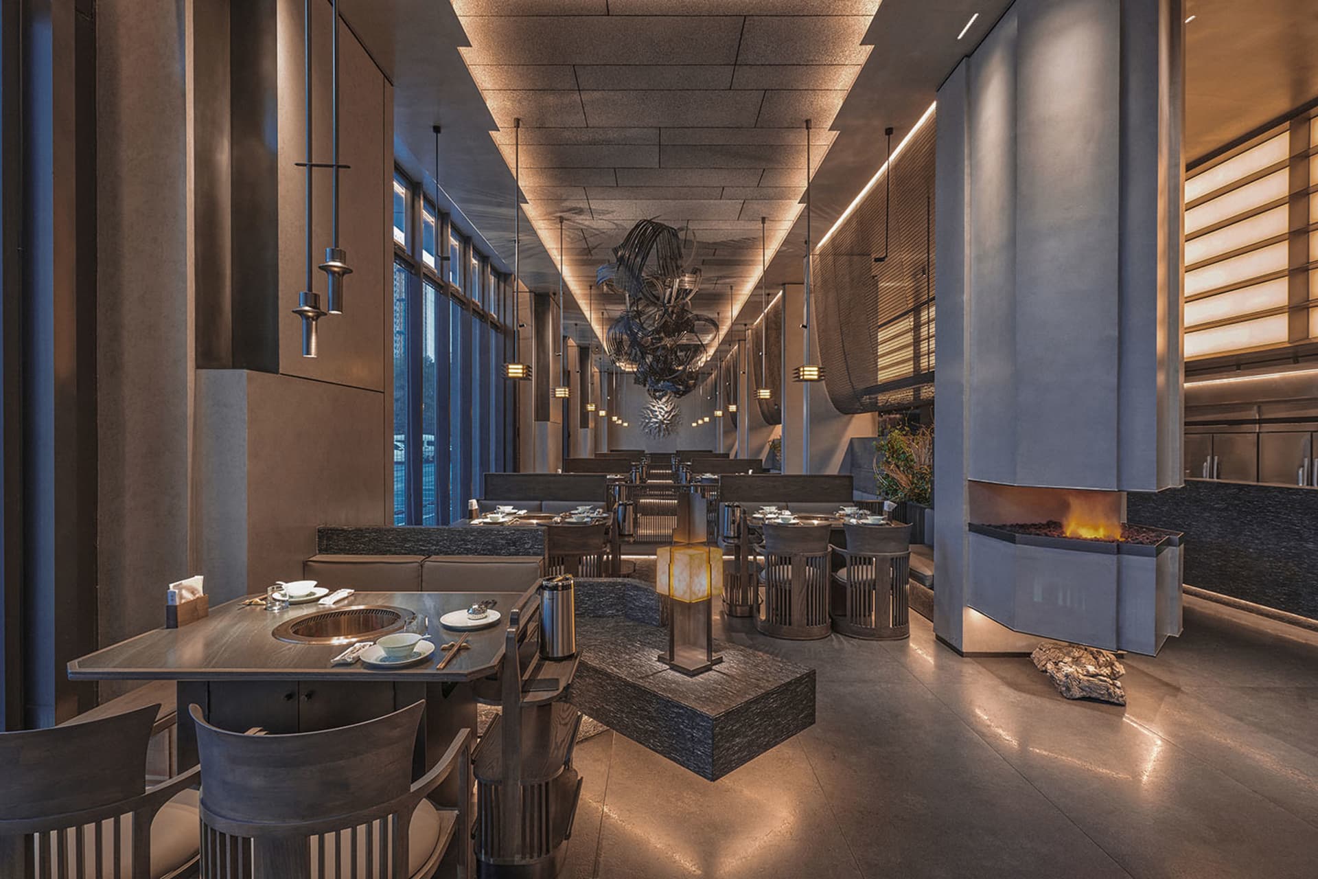Modern restaurant interior featuring metal, wood, and stone materials.