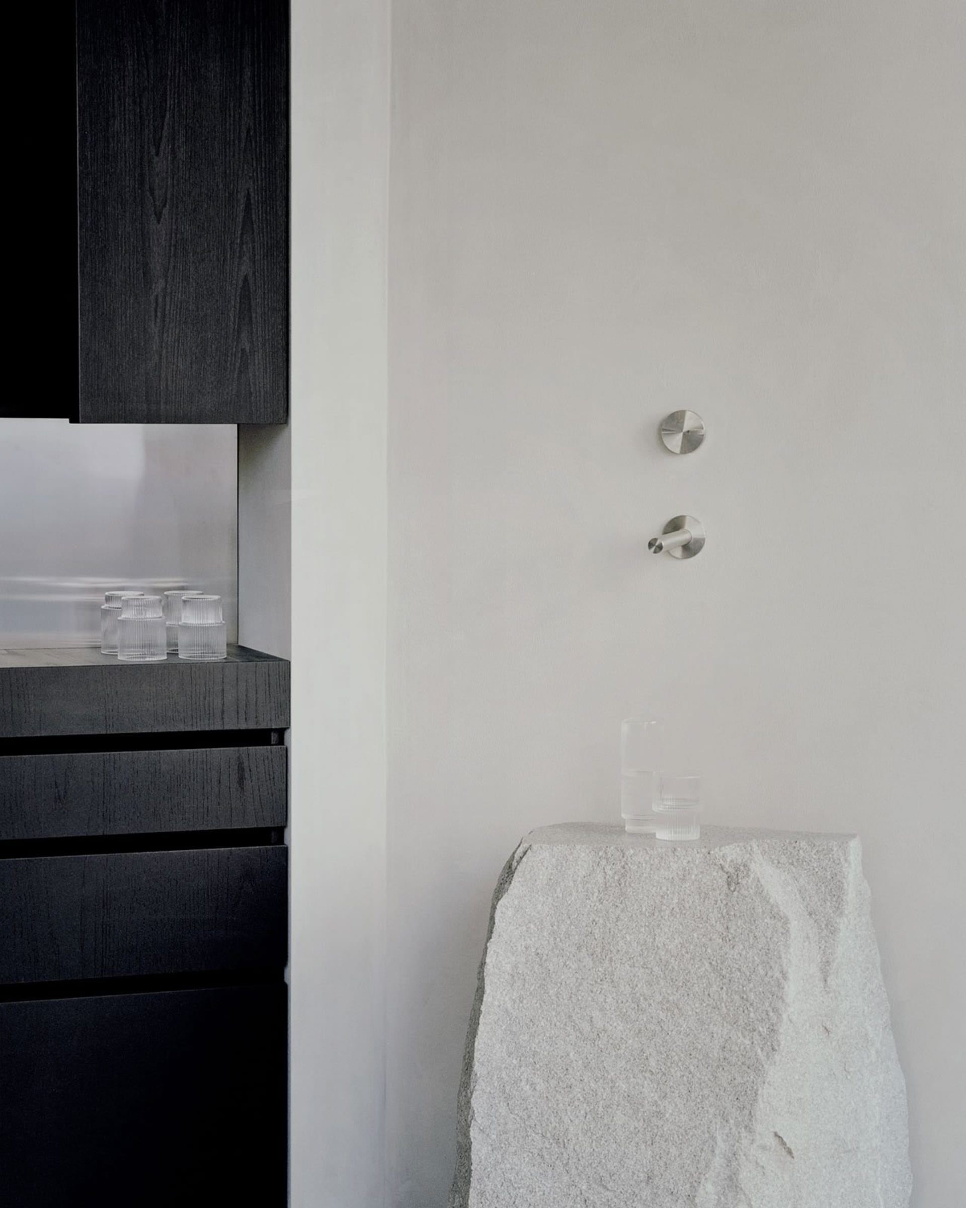 A minimalist interior design featuring modern elements made of glass and marble.
