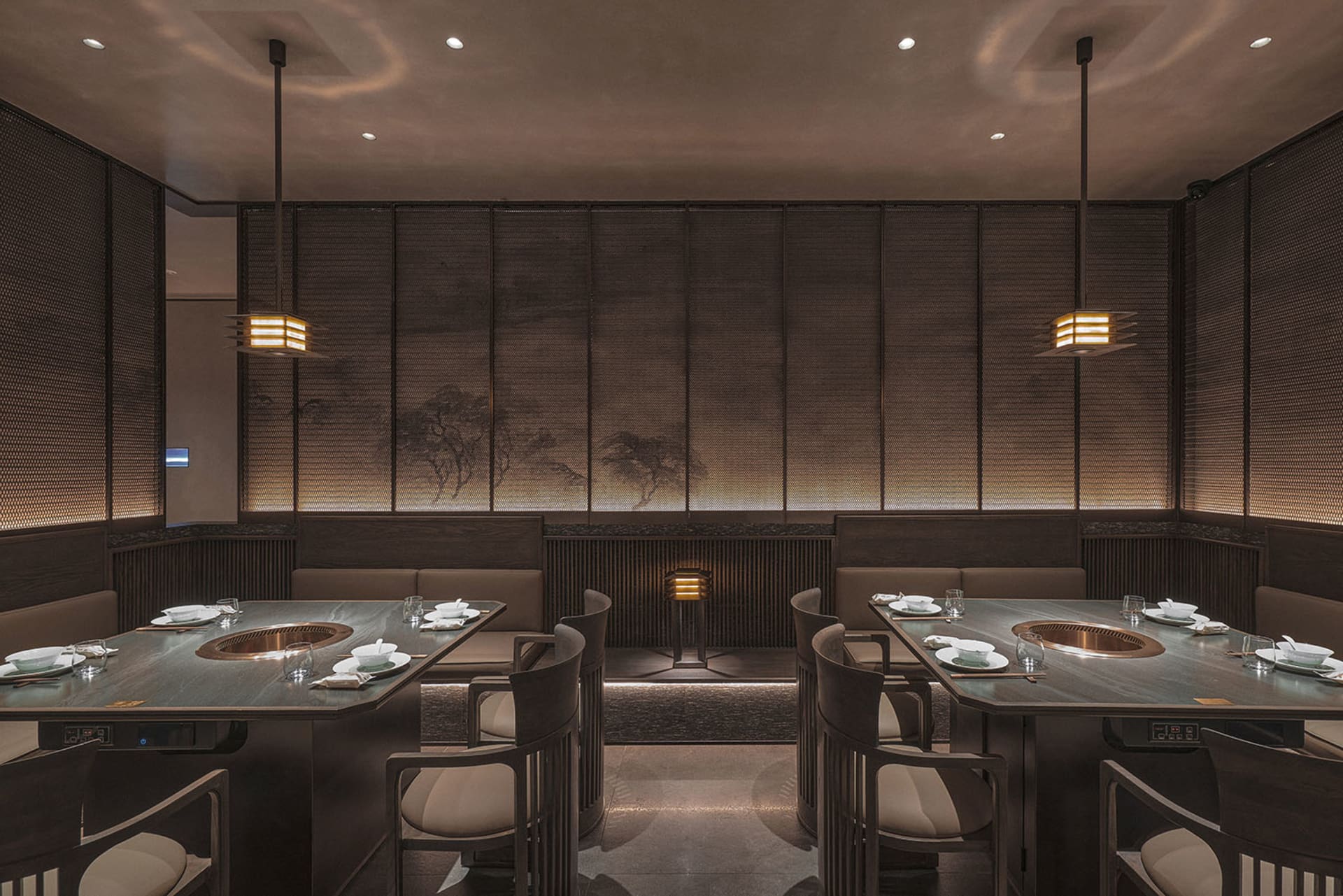 Modern restaurant interior with dark oak tables, white fabric seating, and minimalist lighting