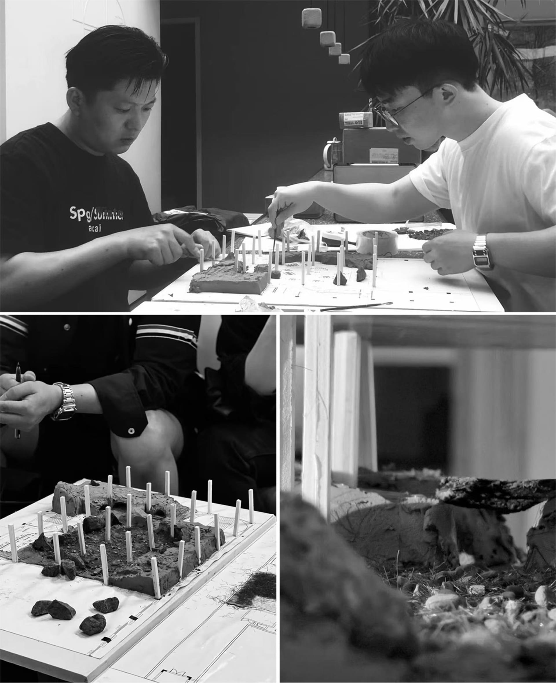 A black and white image of two individuals meticulously crafting a clay architectural model with numerous miniature poles and