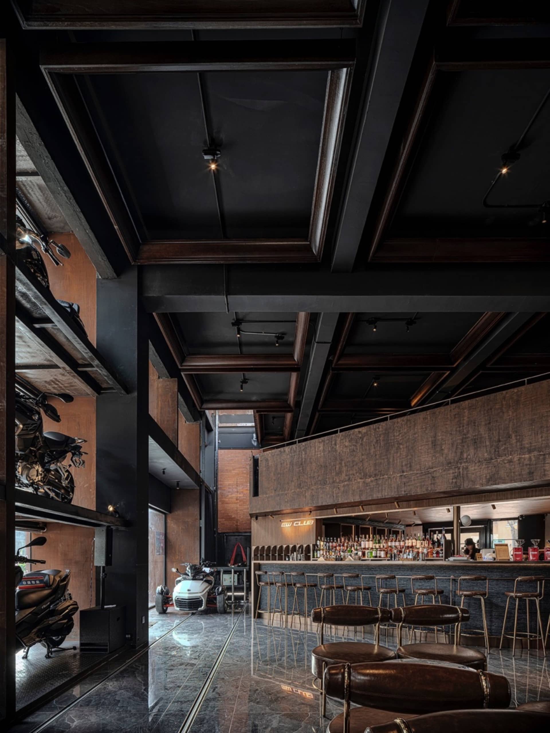 Modern coffee shop interior with concrete, wood, metal, and glass materials.