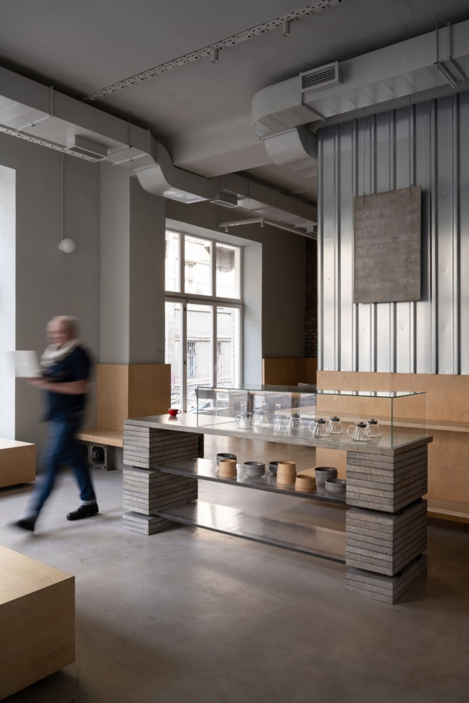 Modern cafe interior with concrete flooring and wooden furniture