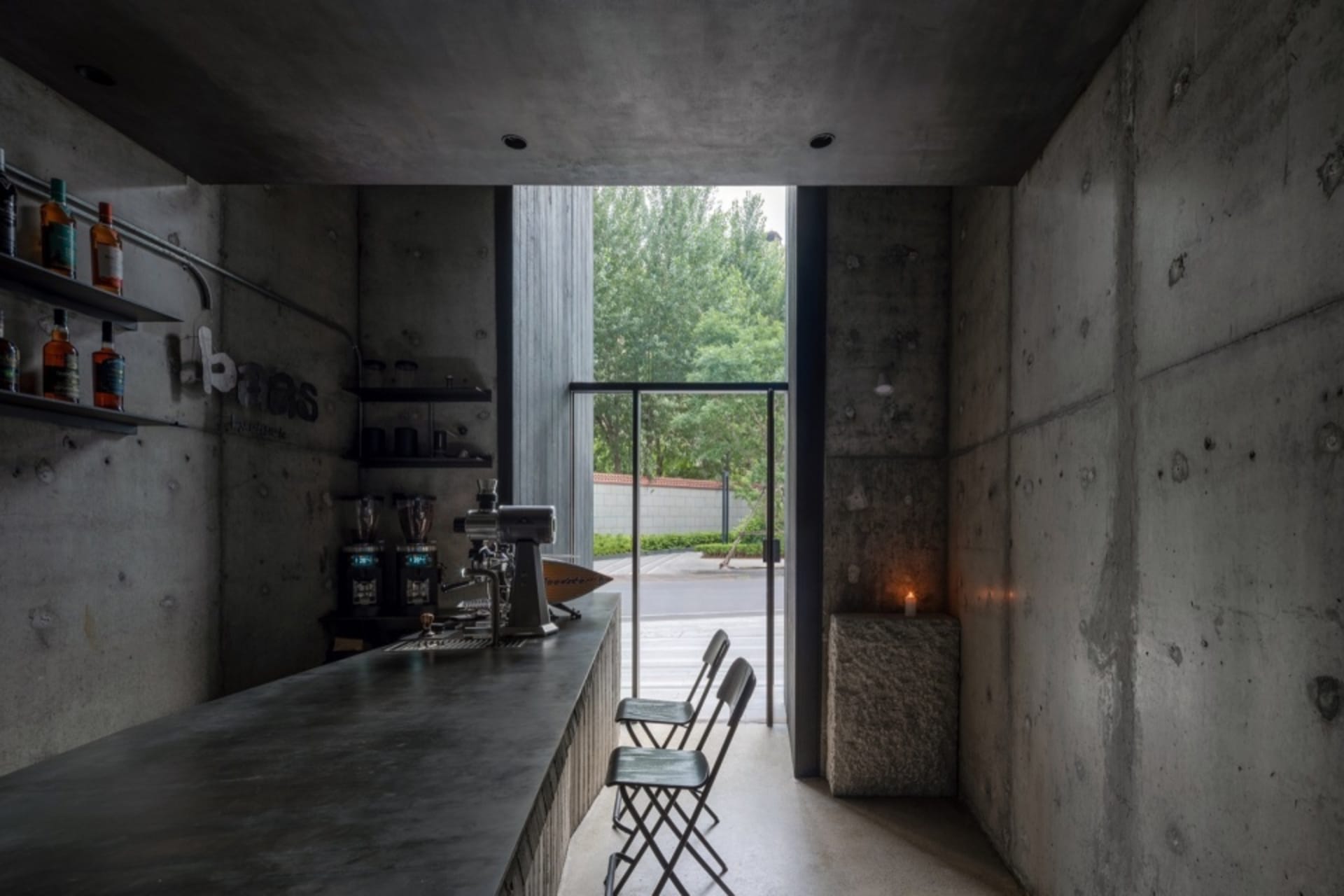 Industrial-styled coffee shop bar with concrete desk and minimalist design