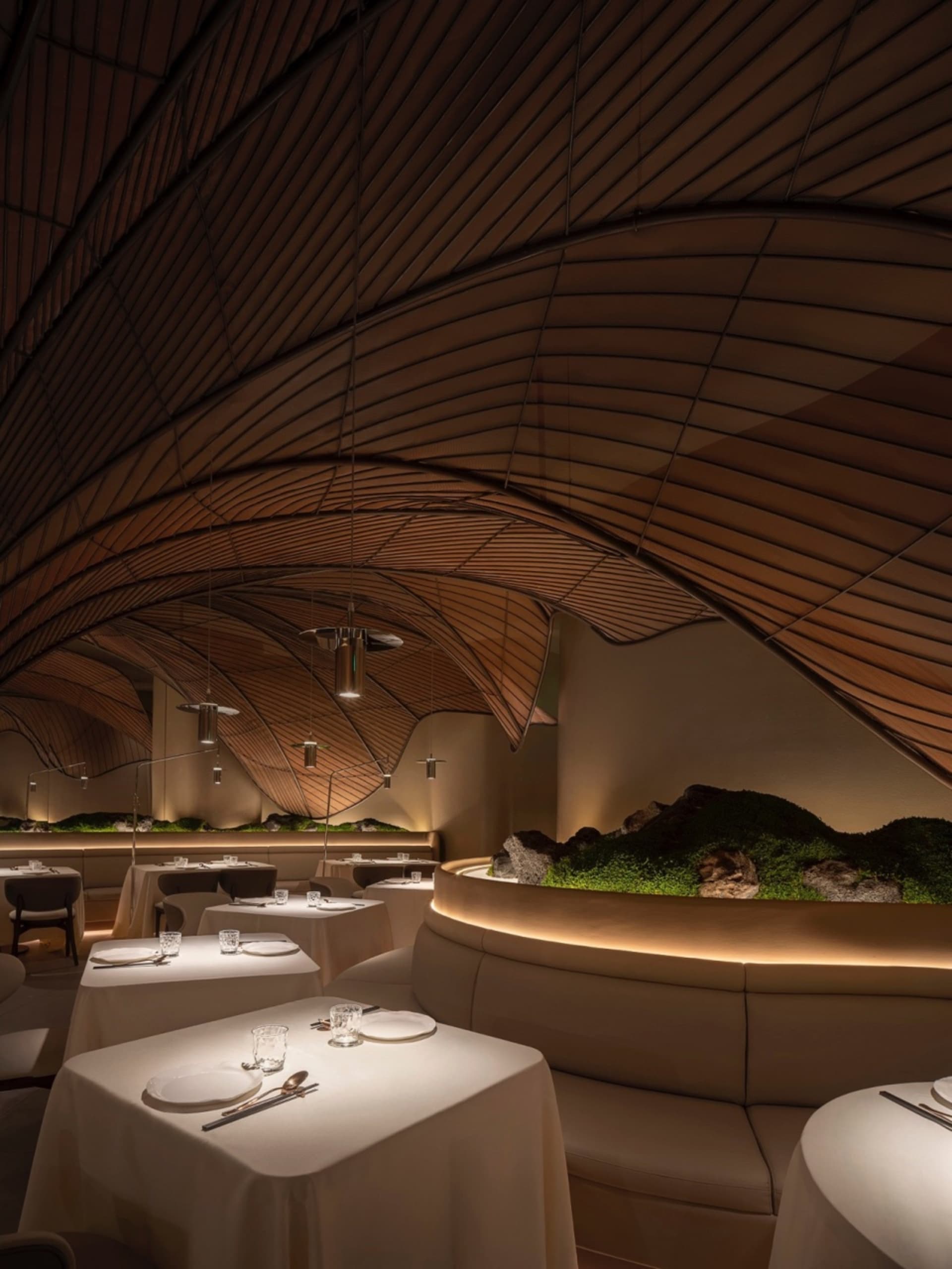 A modern restaurant interior with wooden materials and a sophisticated design.