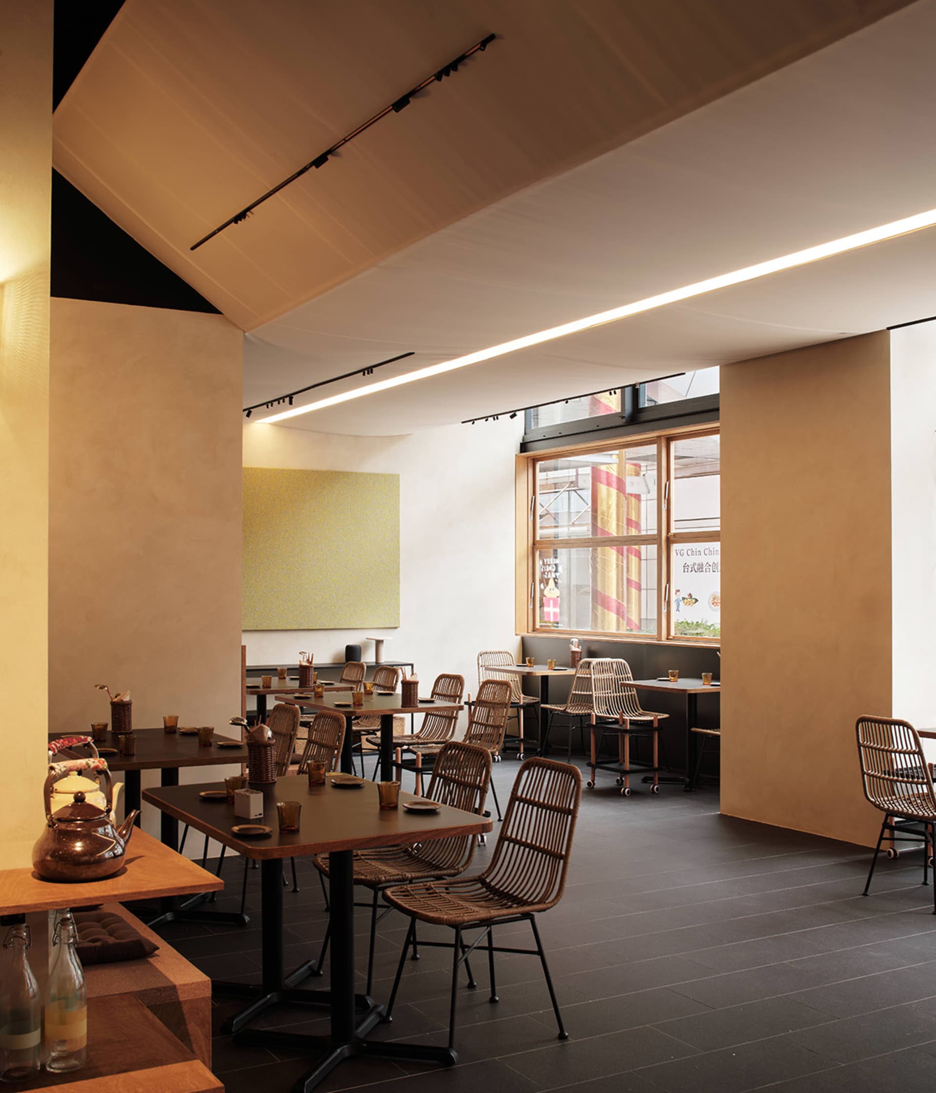 A minimalistic restaurant interior featuring wood and metal elements.