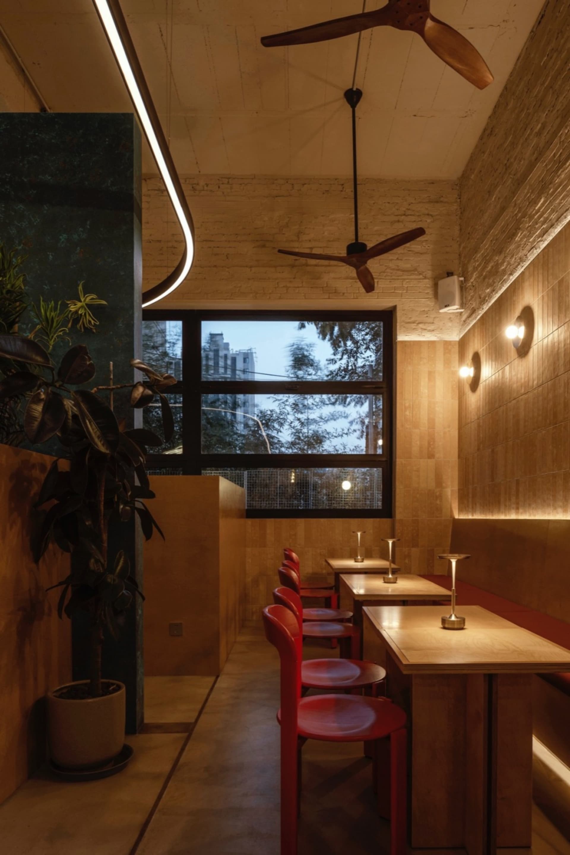 Modern cafe interior with wooden furniture and brick walls