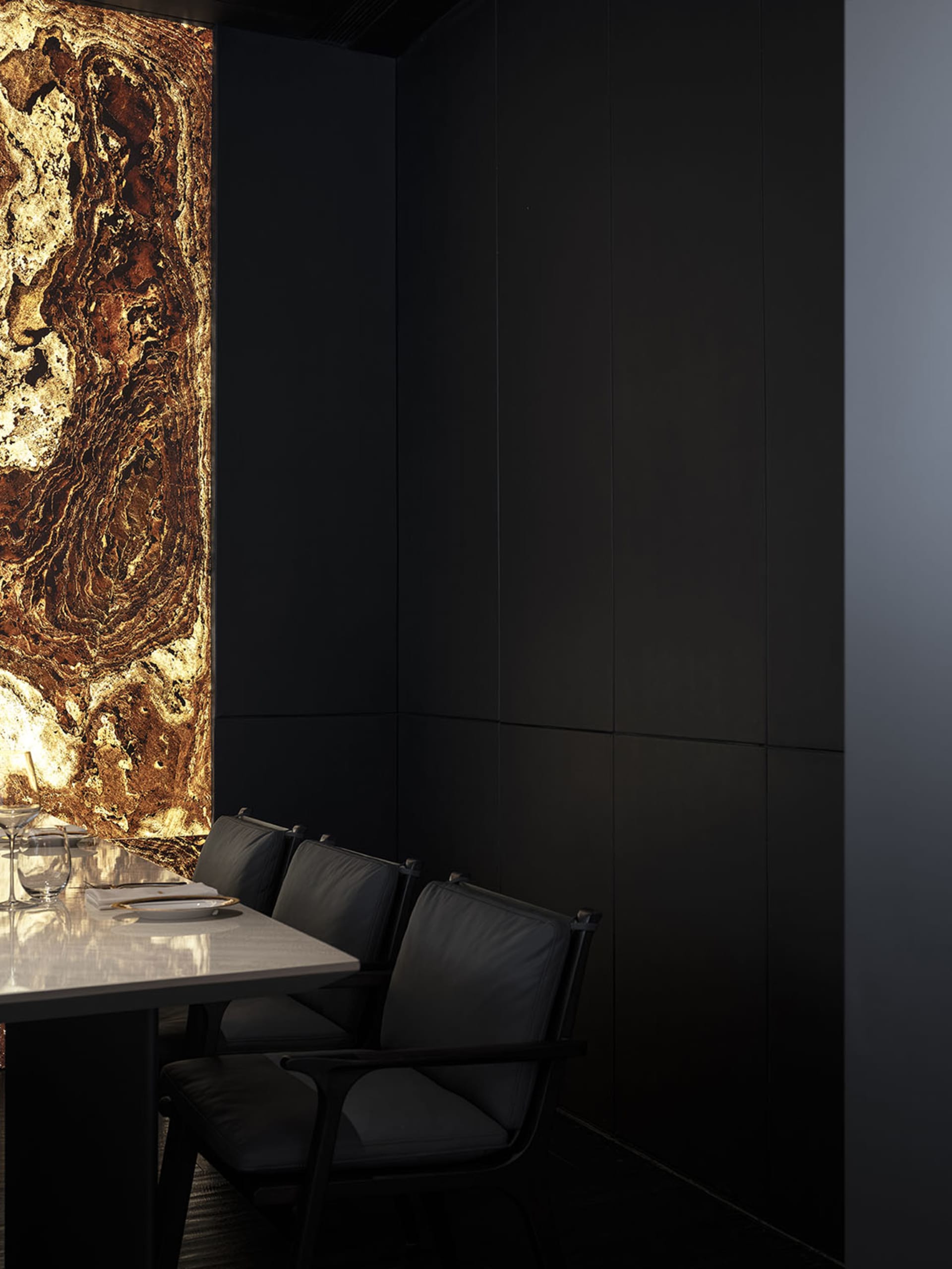 Modern restaurant interior featuring a striking marble wall