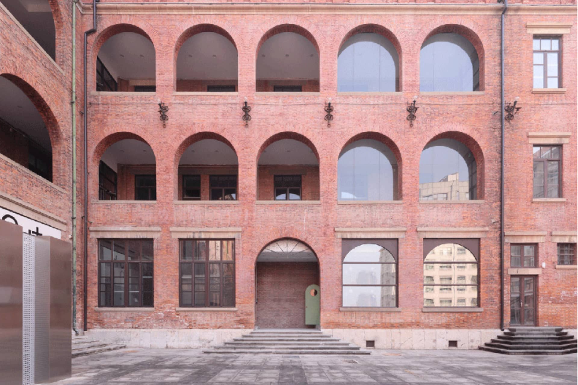 Red brick exterior with arch windows and doors.
