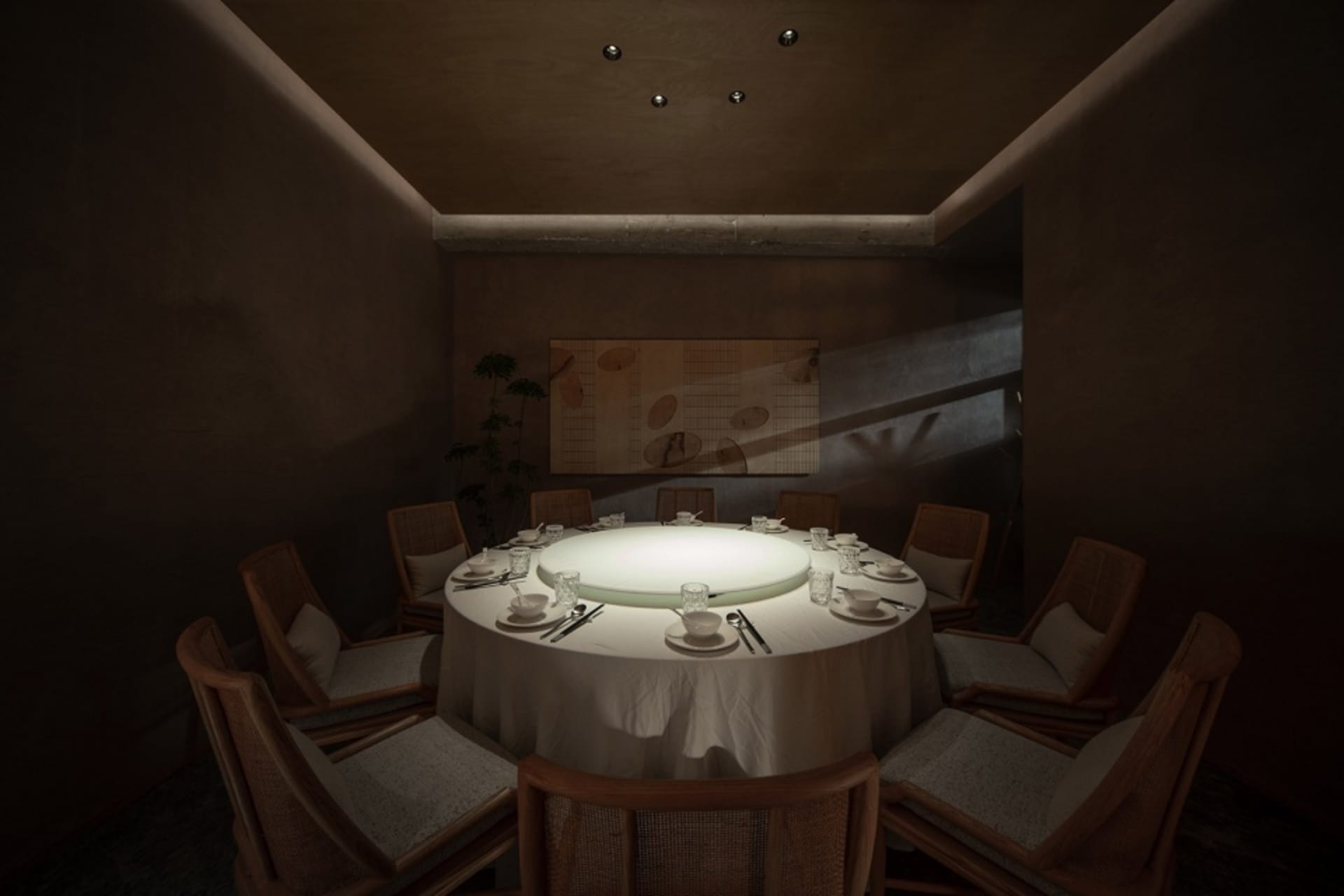 Modern restaurant interior with a round dining table, upholstered chairs, and soft lighting