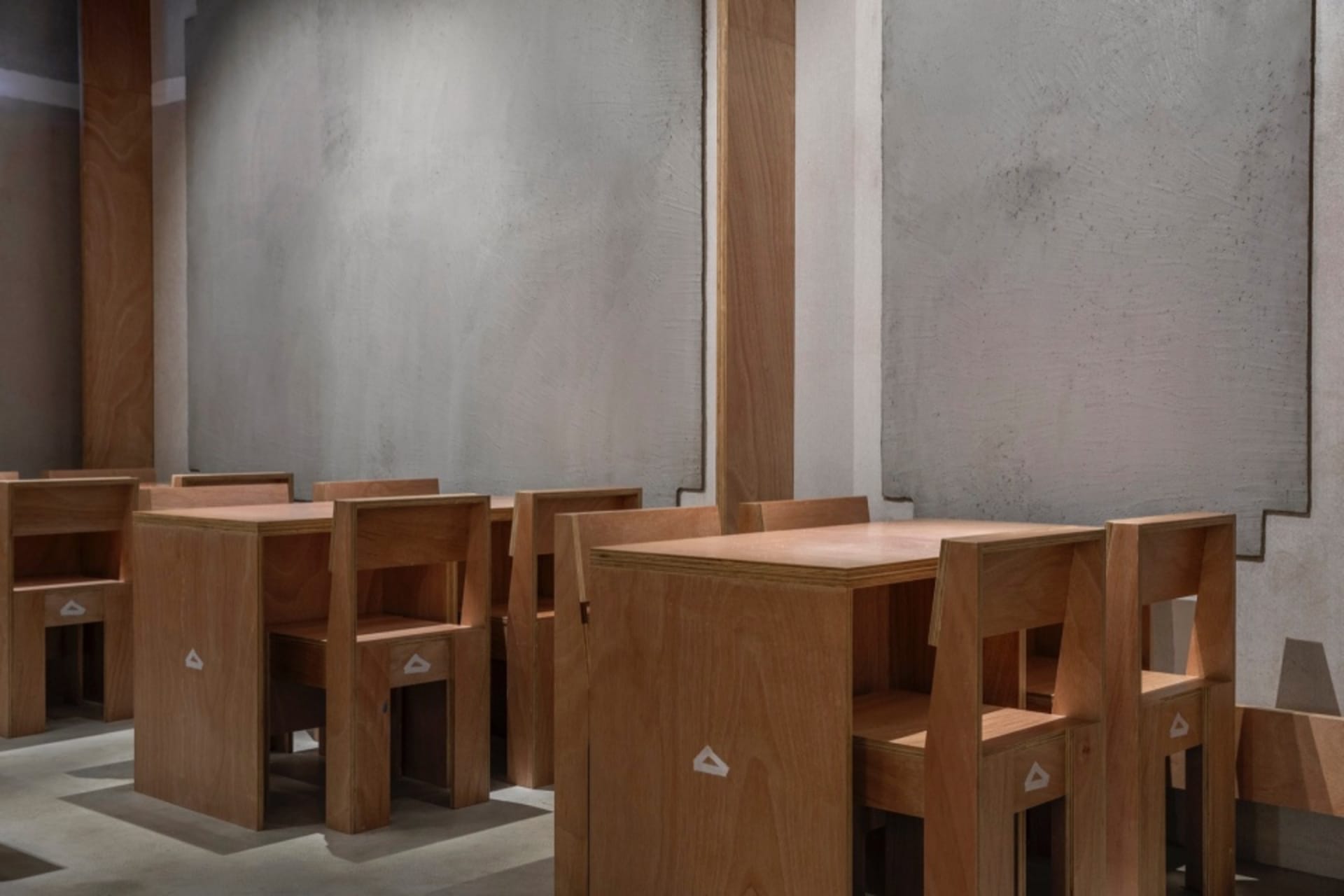 Modern minimalist library featuring wooden tables and chairs