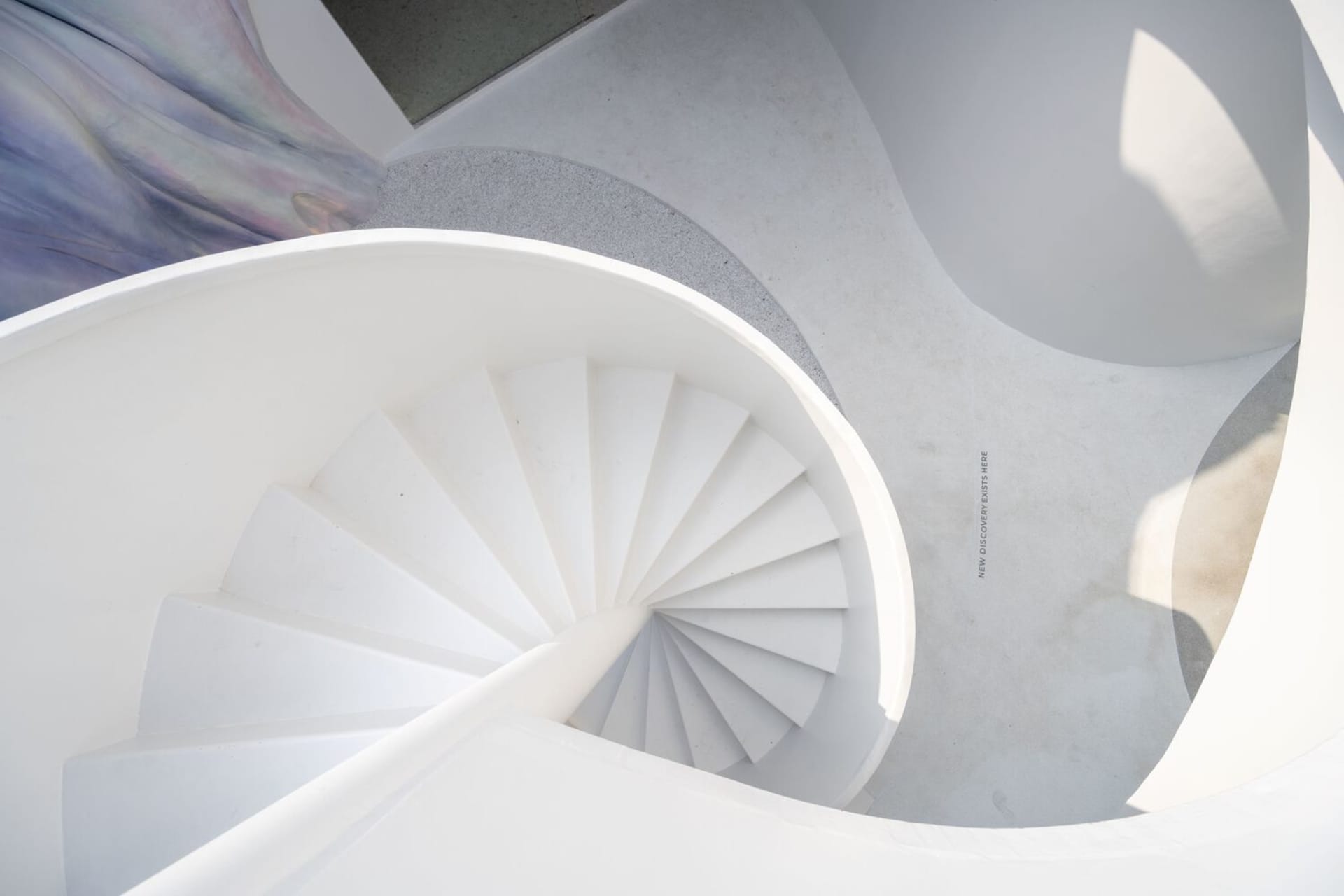 A minimalist white staircase rendered in a concrete-like material.