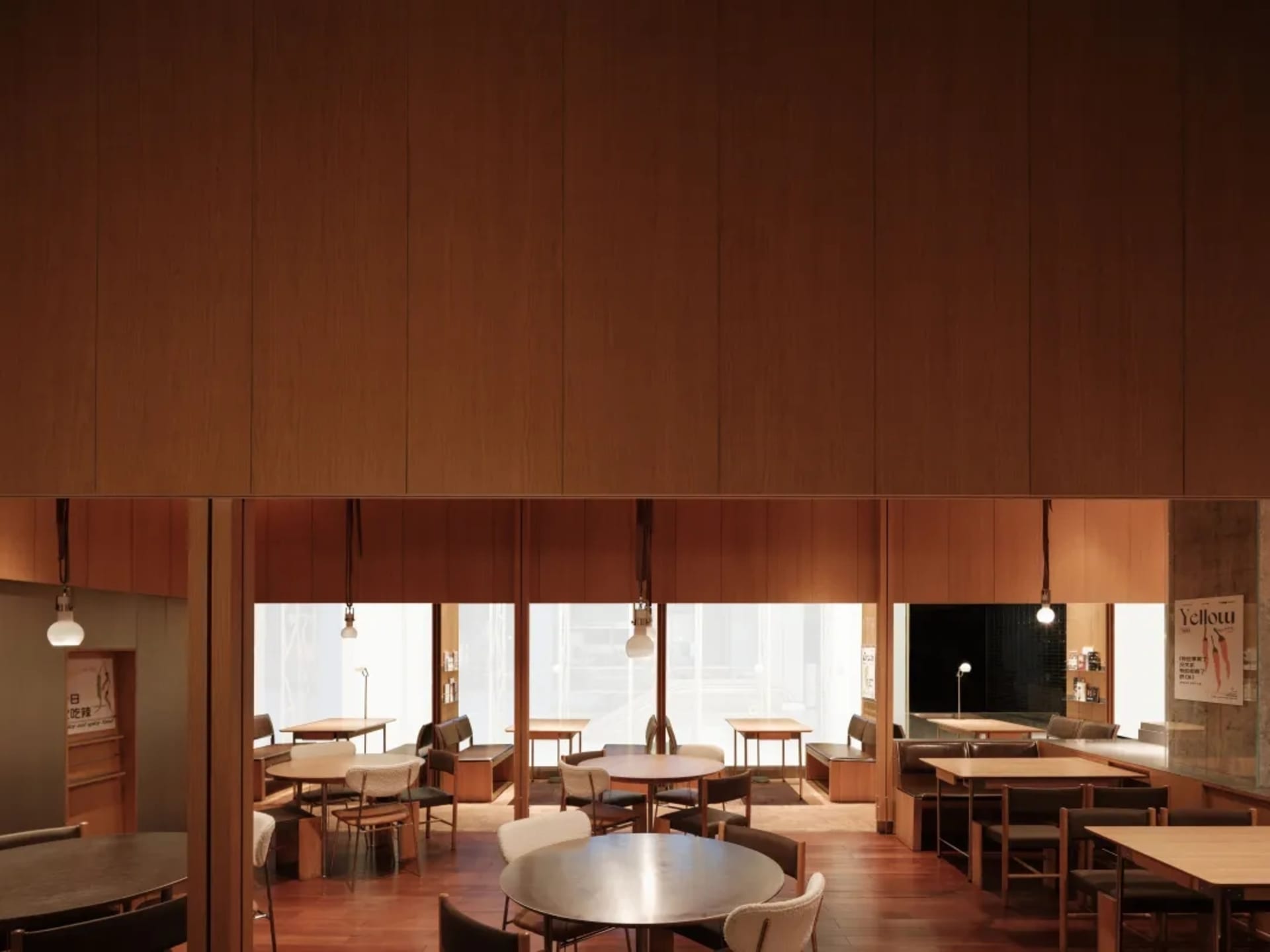 A modern, minimalist restaurant interior with wooden walls and tables, clean lines and open space.