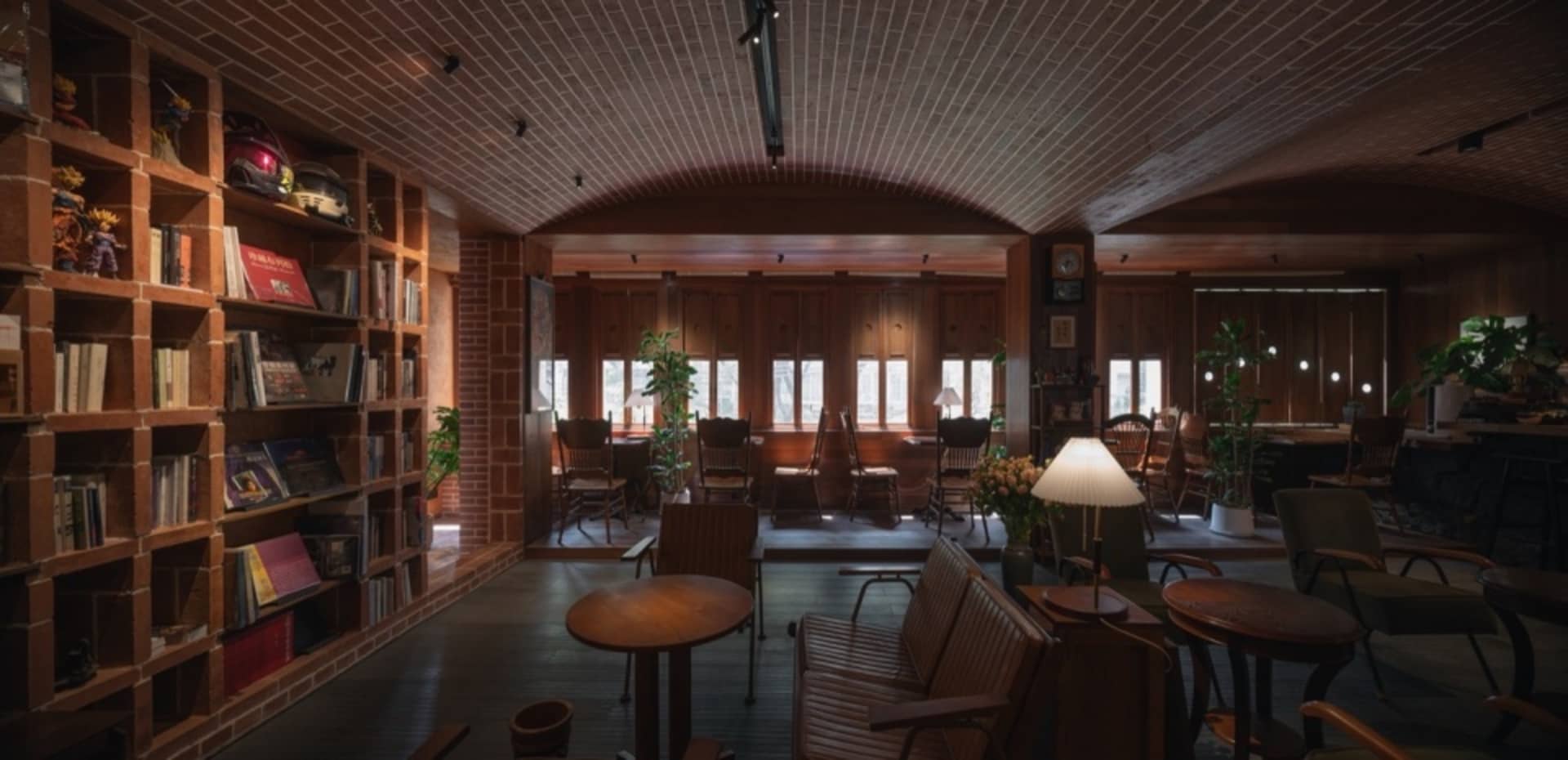 A cozy cafe with rustic brick walls, concrete flooring, and wooden furniture.