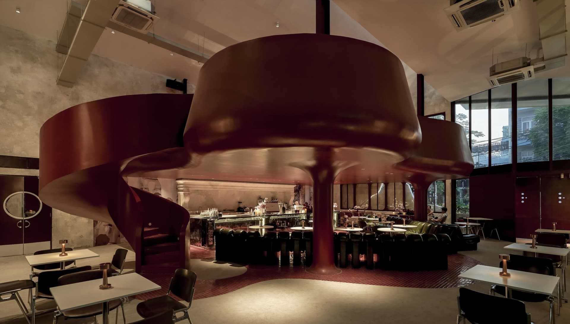 A modern industrial-style restaurant interior with a metal bar counter.