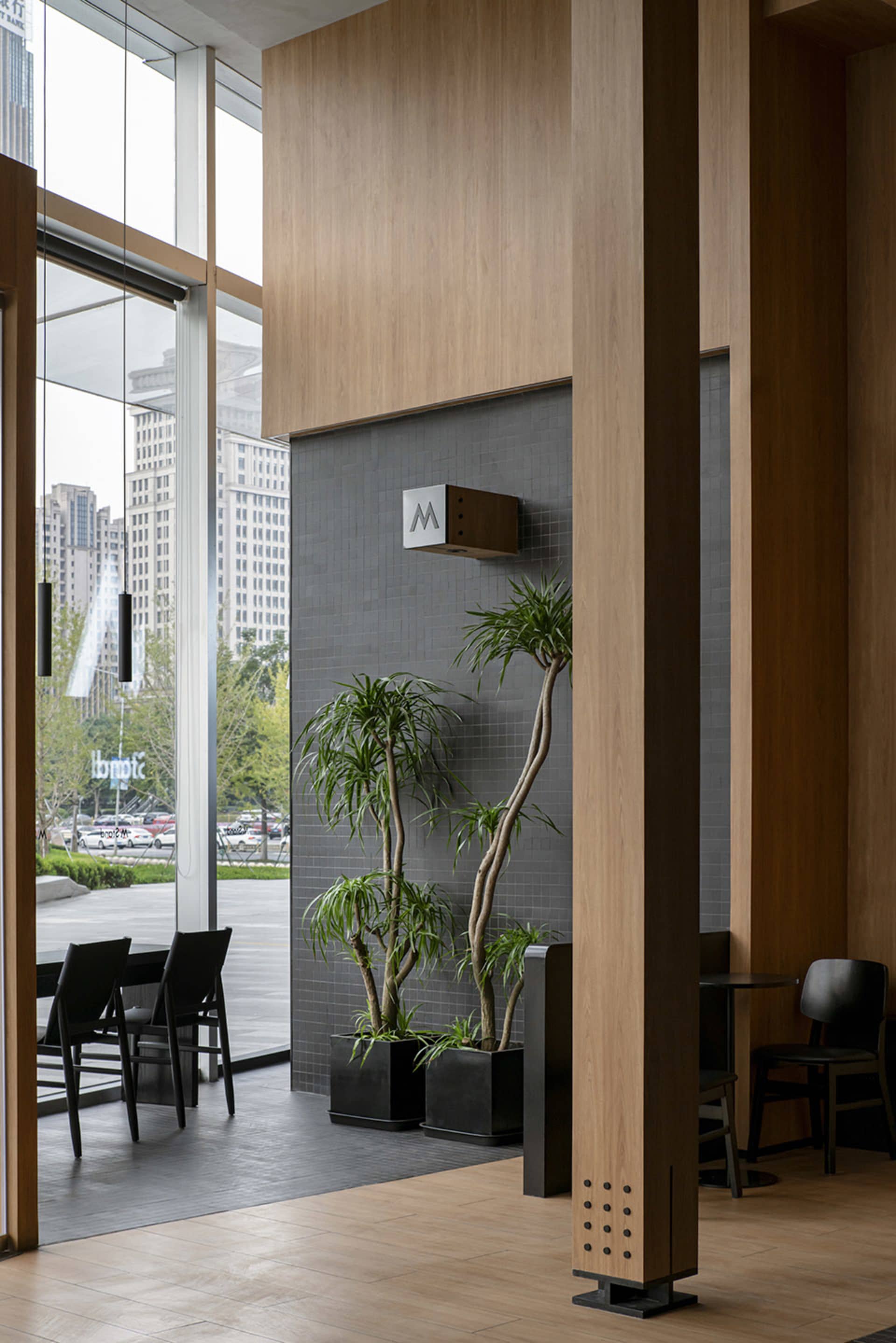Modern interior design featuring wooden walls, glass windows, and stone tiles
