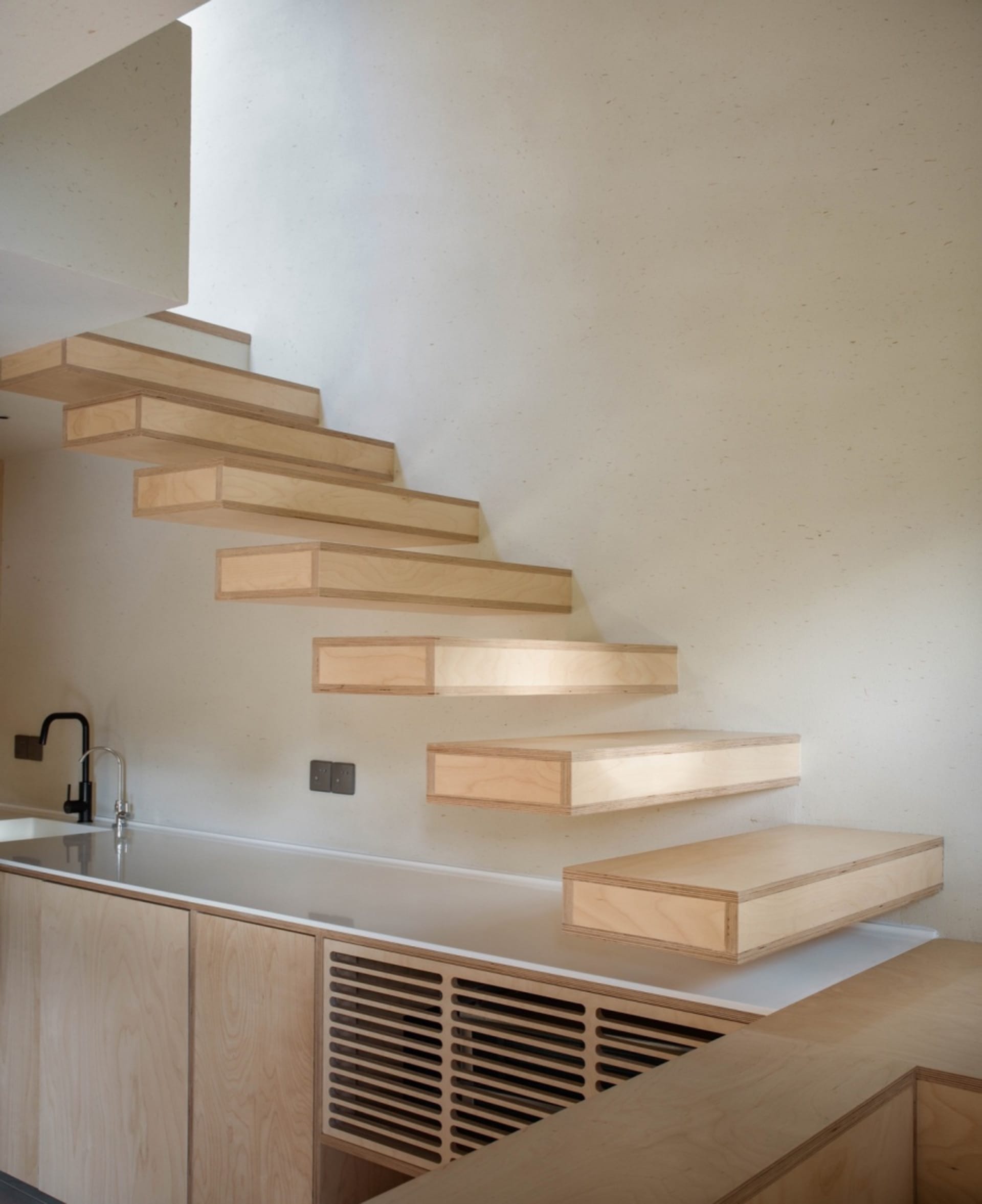 Floating wooden staircase in a modern kitchen