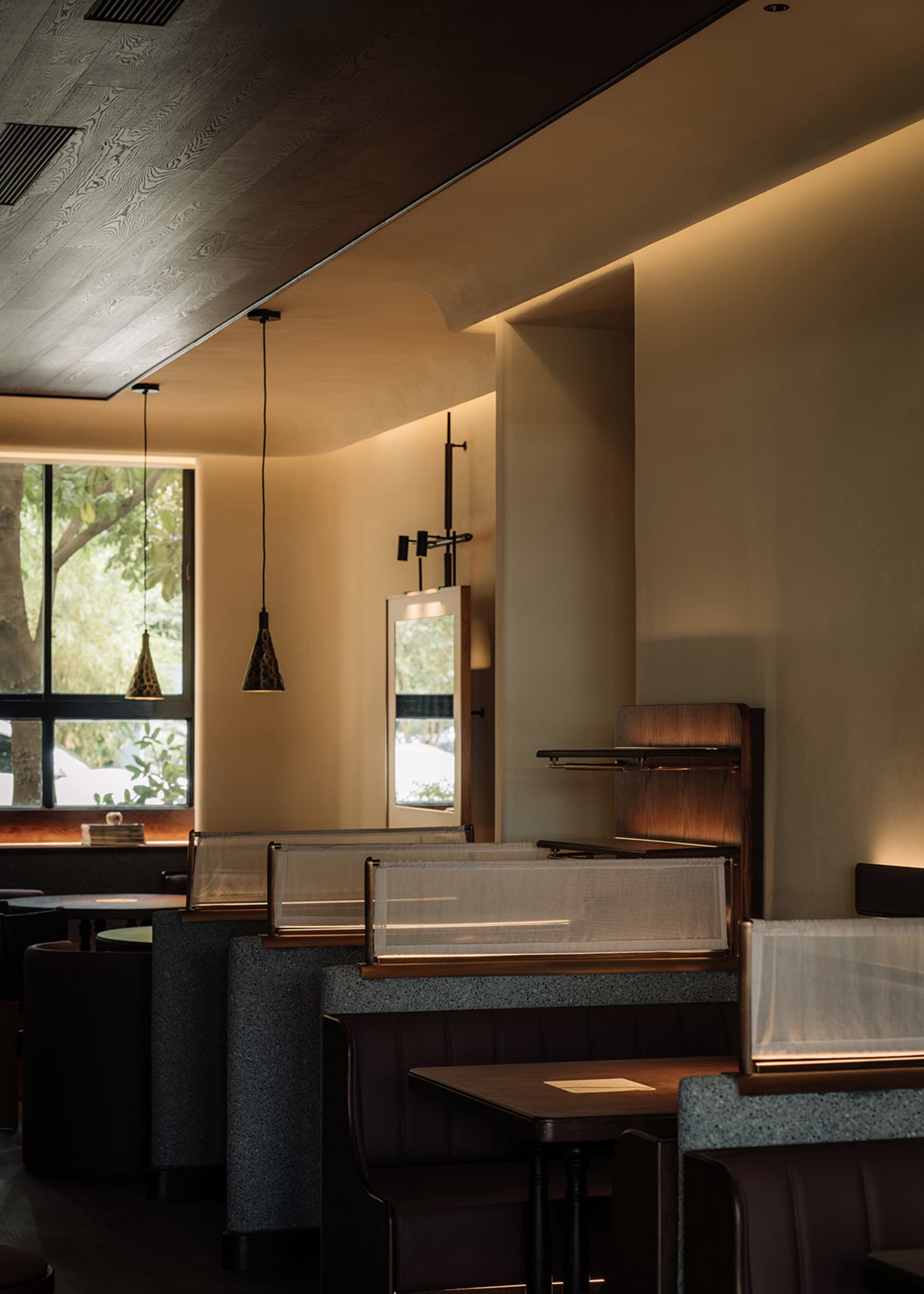 Modern restaurant interior featuring concrete materials and contemporary design elements.