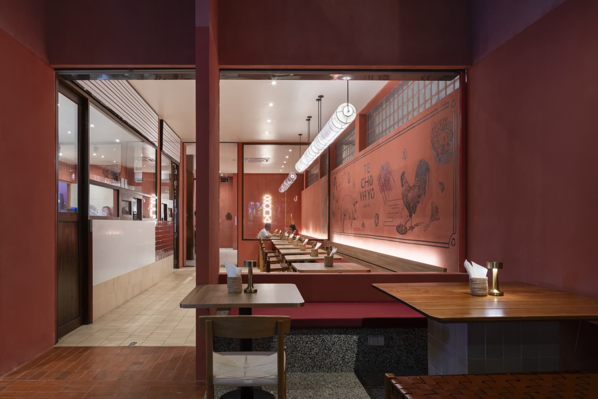 Modern restaurant interior featuring wooden furniture and concrete floor
