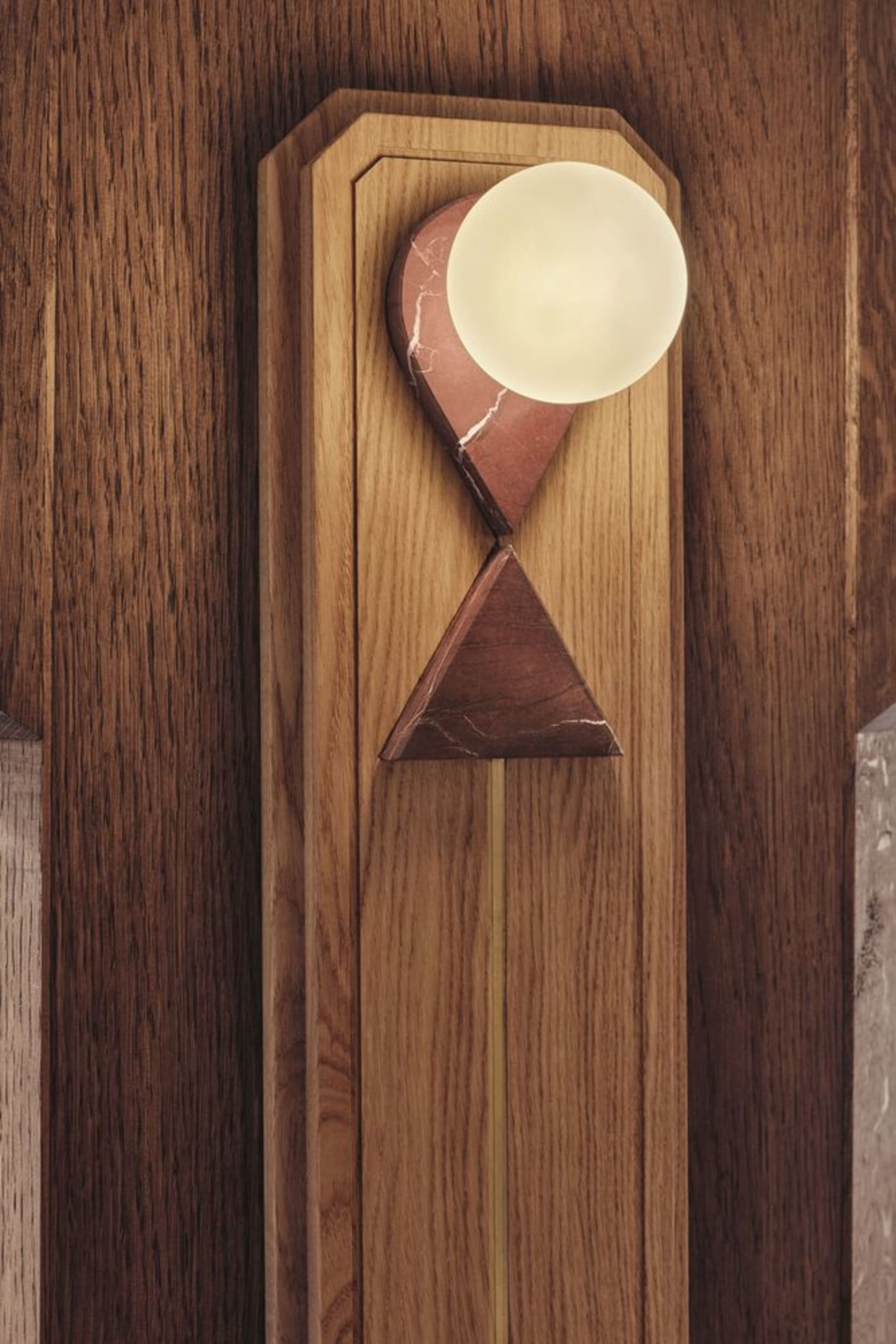 Modern lighting fixture with a combination of wood, marble, and brass materials.
