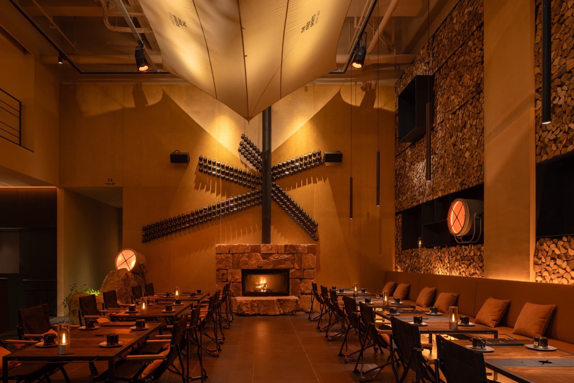 An industrial-style restaurant with metal, wood, and stone elements.