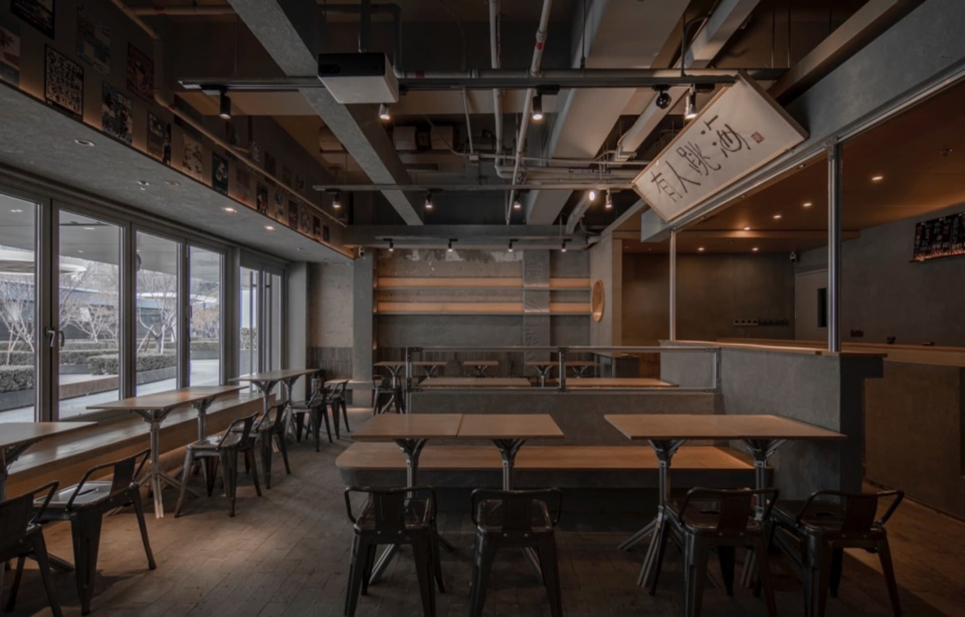 Industrial-style restaurant interior with concrete, wood, and metal elements.