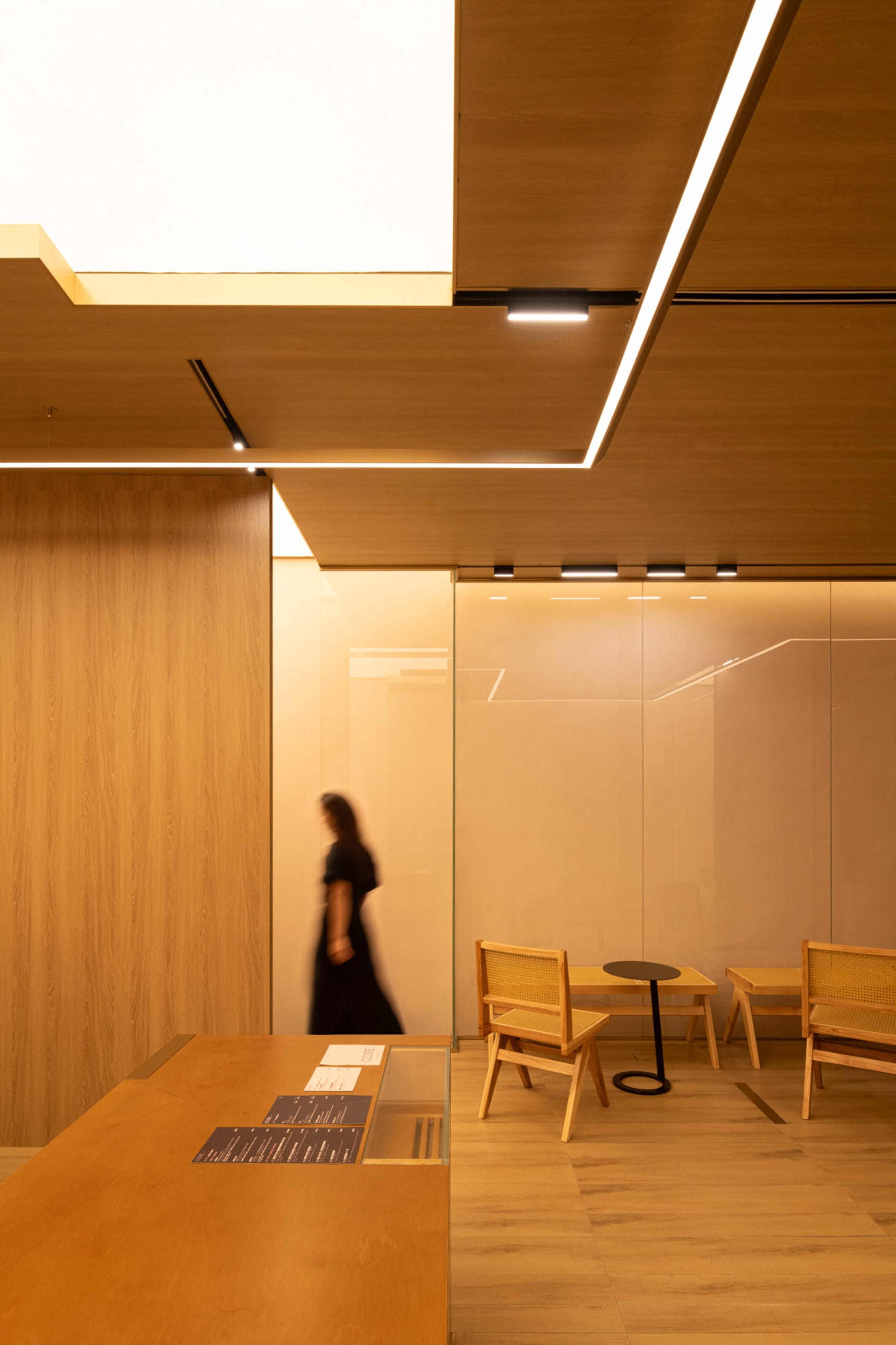 A modern office lounge area with wooden materials and clean lines.