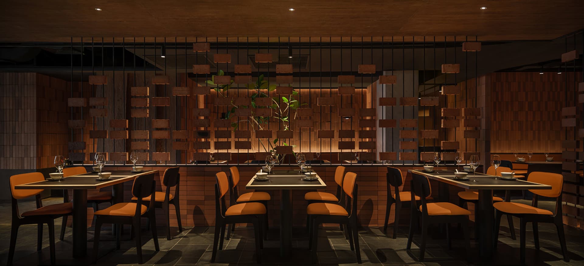 Modern restaurant interior with brick and wood accents, featuring sleek tables and chairs.