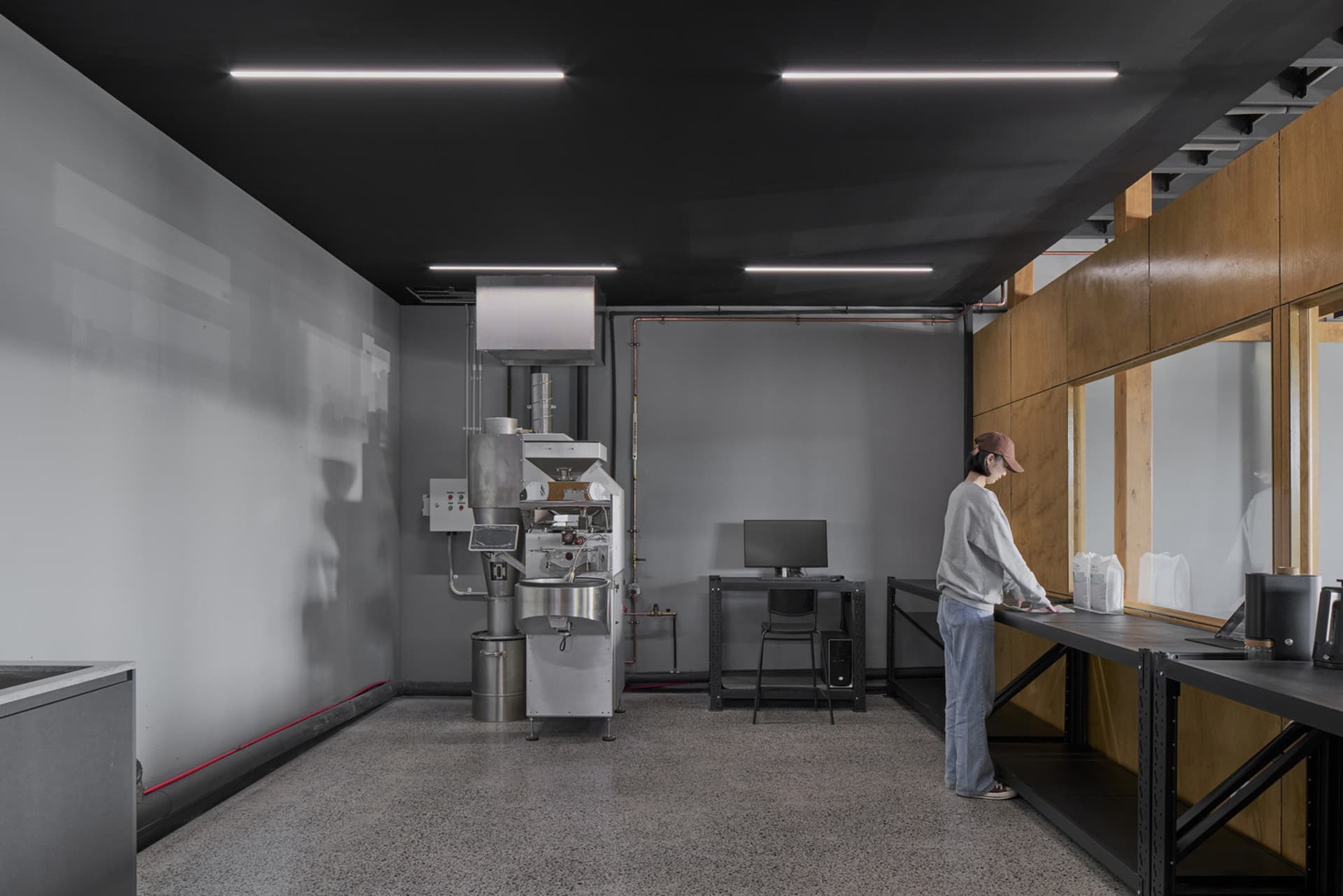 A modern, spacious coffee processing facility with metal accents and functional design.