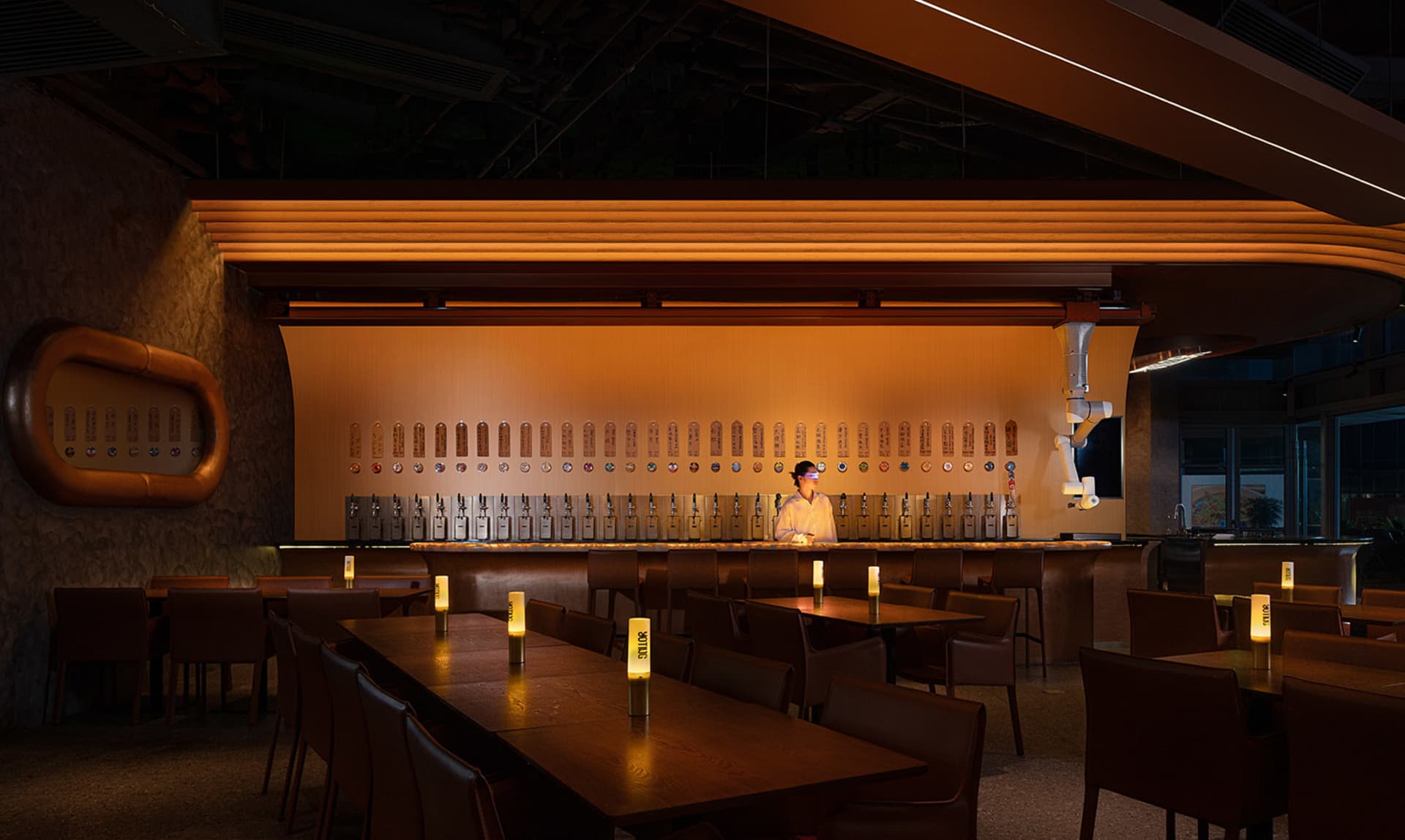 A modern bar interior with industrial design elements and warm lighting.