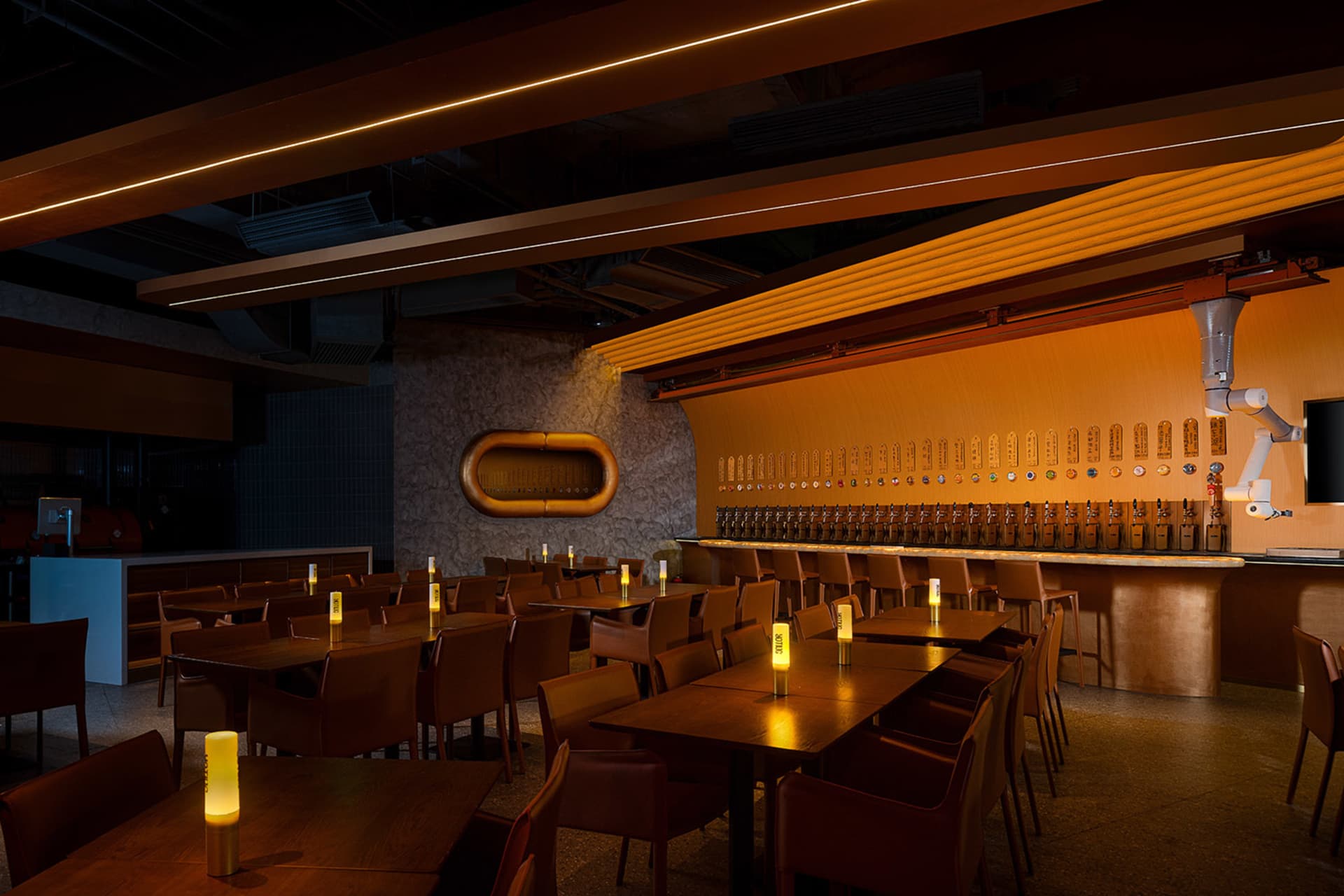 A modern restaurant bar with warm lighting and Walnut wood finish