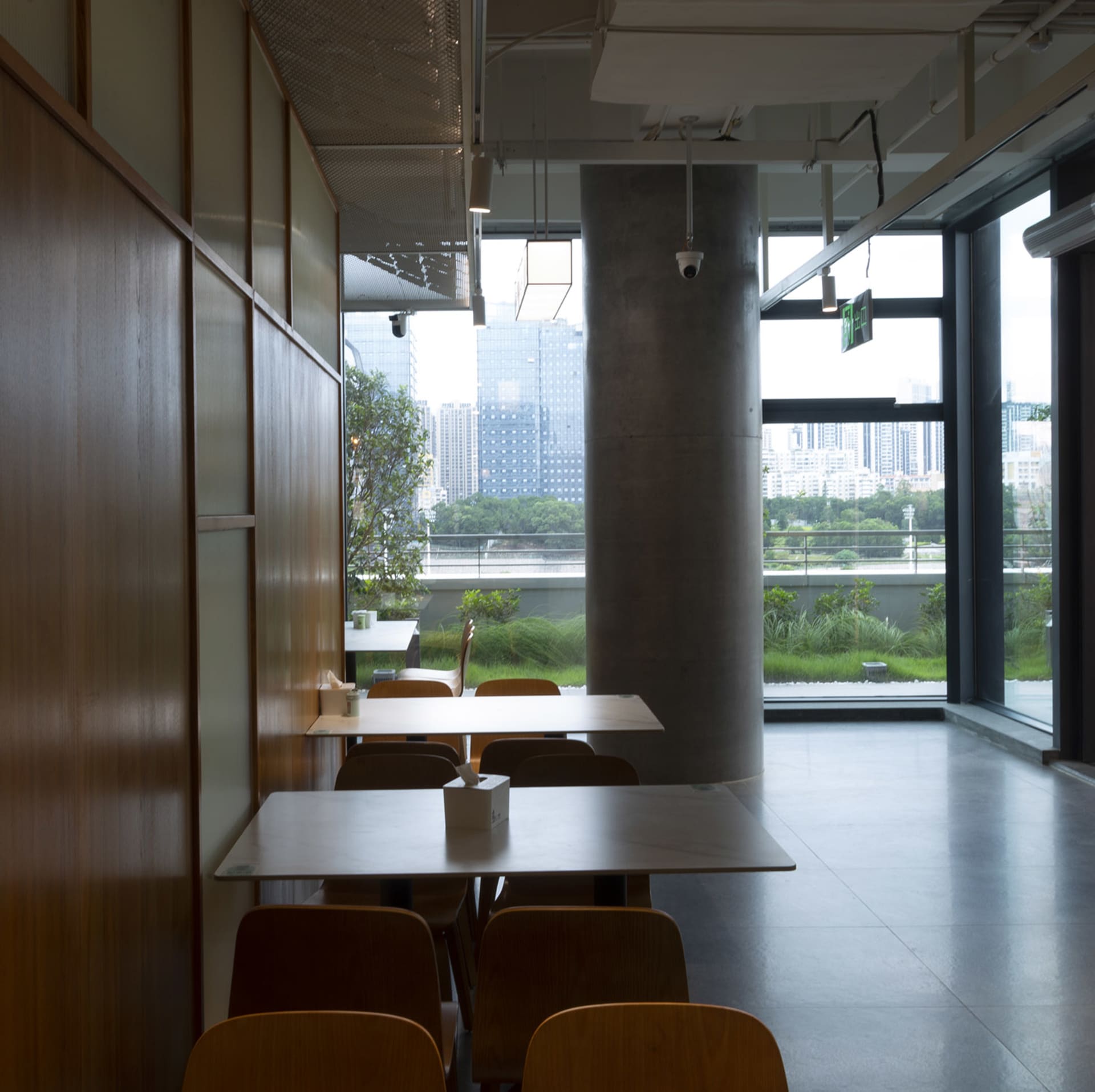 A modern restaurant cafe interior featuring concrete and wooden elements.