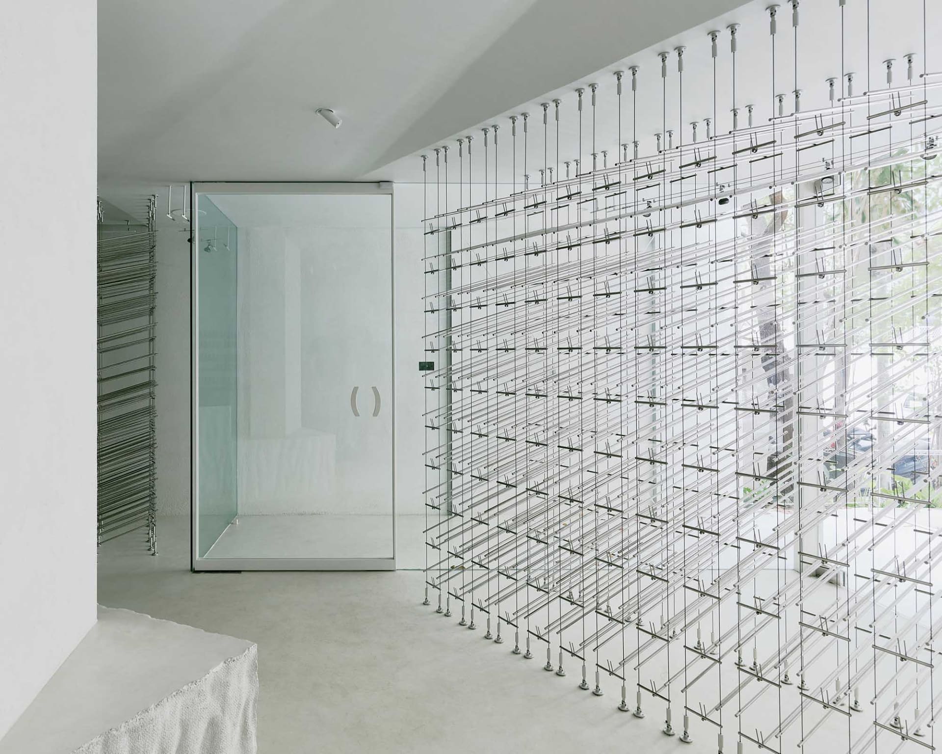 A modern minimalist room interior with a unique metal frame wall design.
