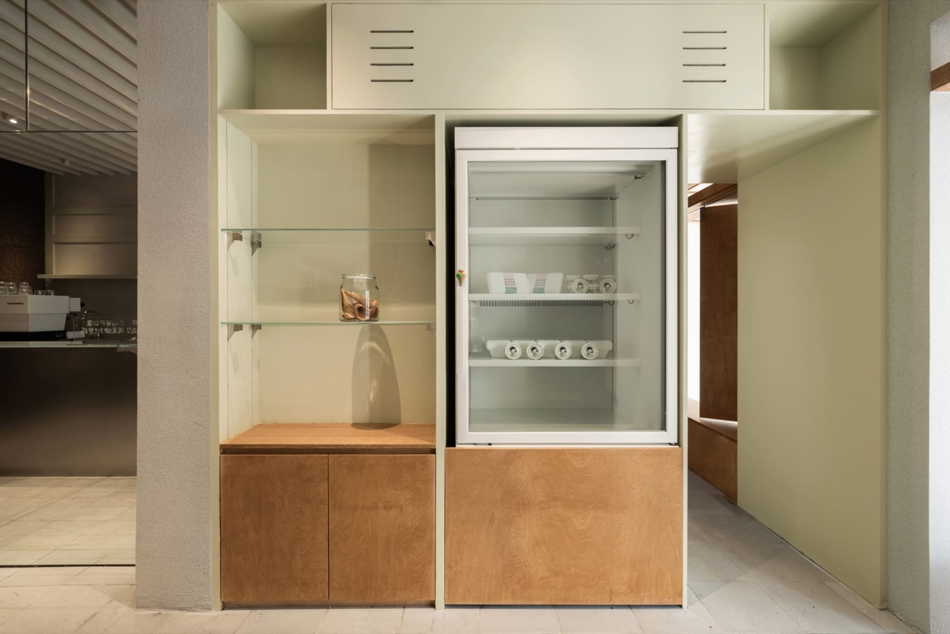 Industrial-themed retail shop display featuring glass cabinets.
