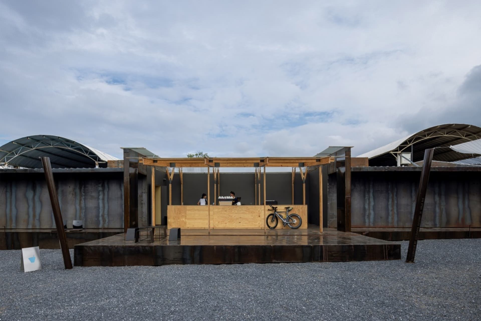 A construction site featuring modern architecture with a tarnished steel facade.