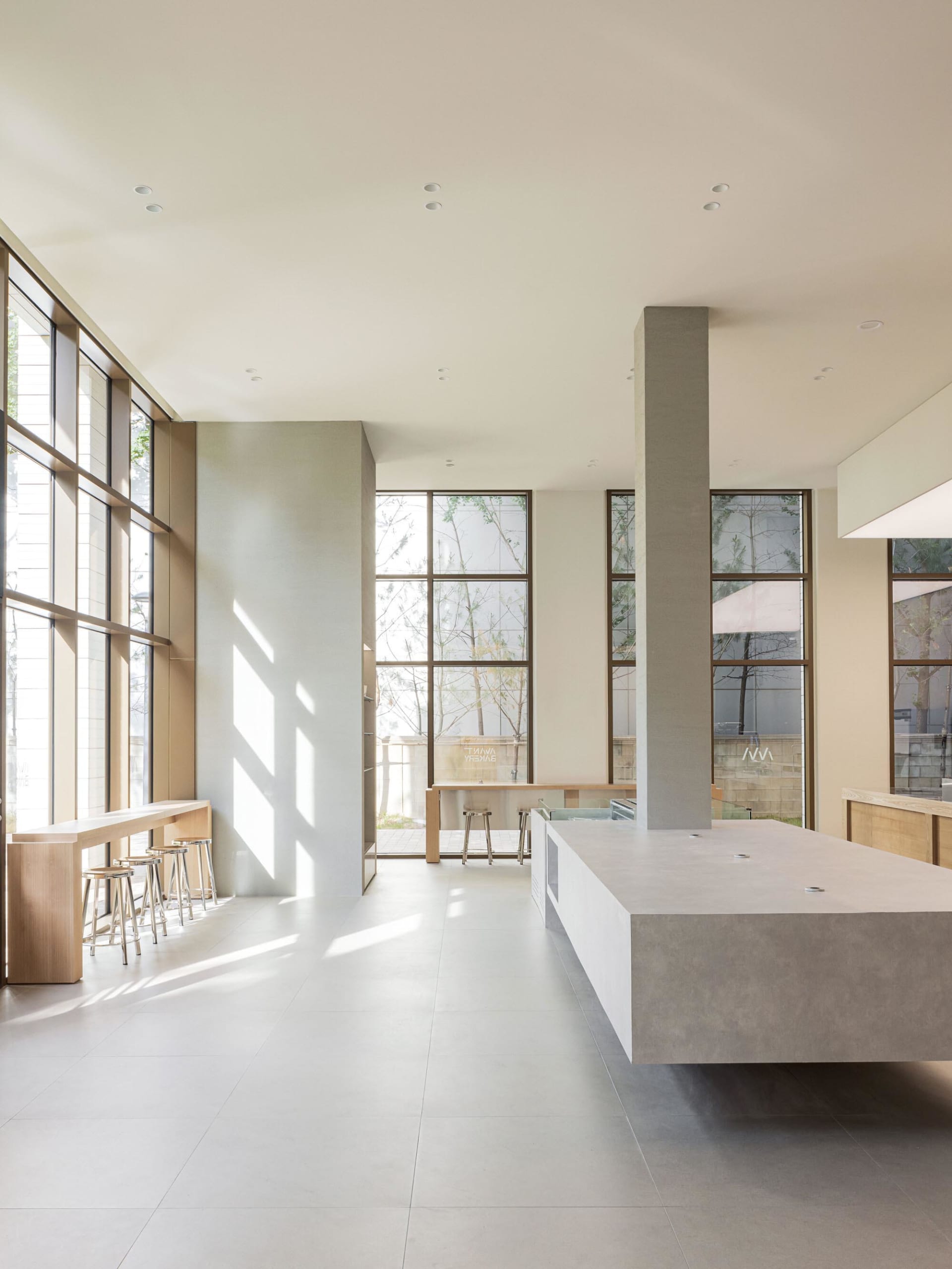 An image of a modern commercial space featuring a combination of concrete and glass materials.